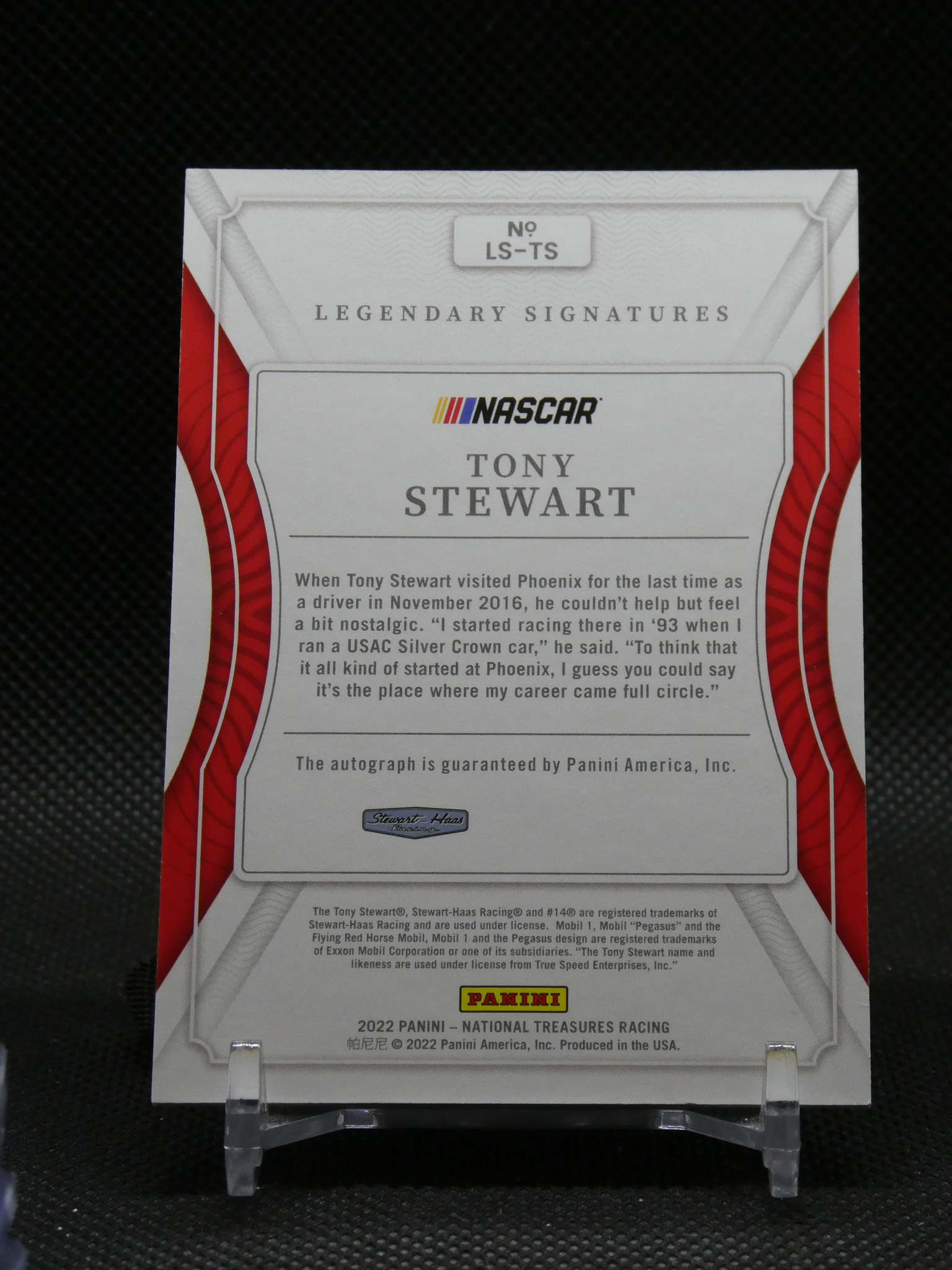 NASCAR Tony Stewart Legendary Signatures card on a display stand with white frame and red side borders.