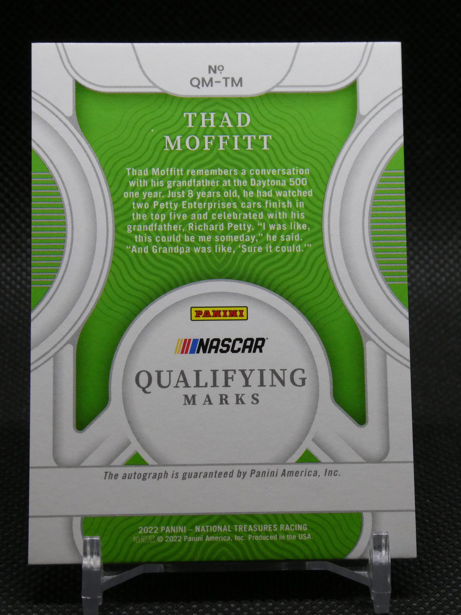 Panini NASCAR qualifying marks trading card with a green decorative panel and the name Thad Moffitt, mounted on a display stand.
