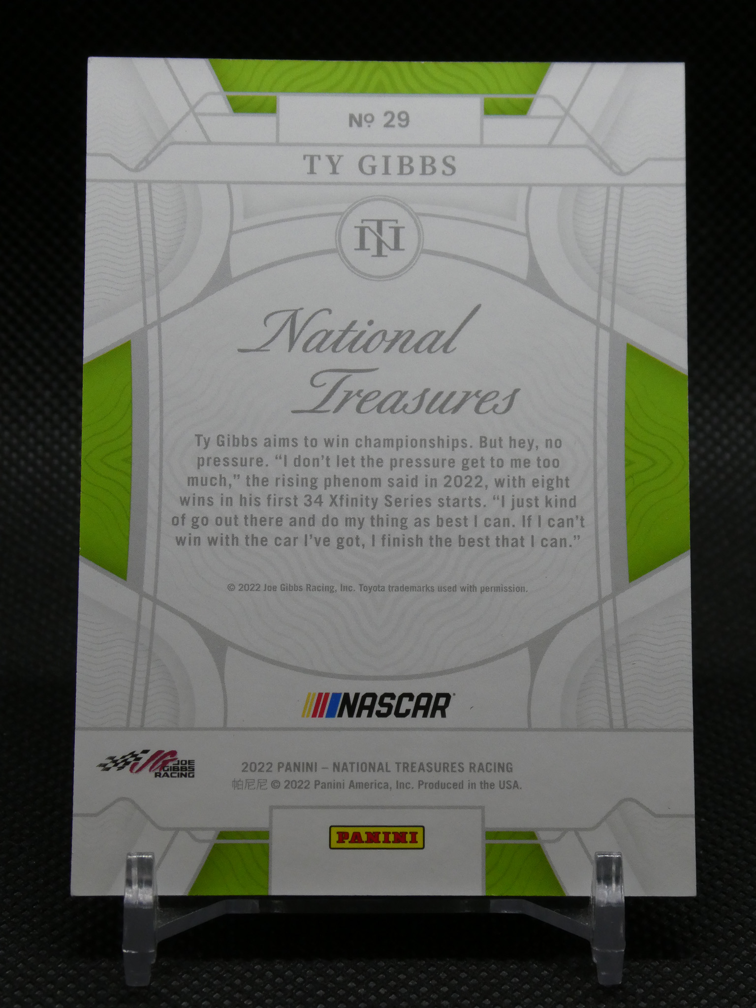 Trading card back for Ty Gibbs No. 29 from Panini National Treasures, with NASCAR logo and green accent panels behind text markups.