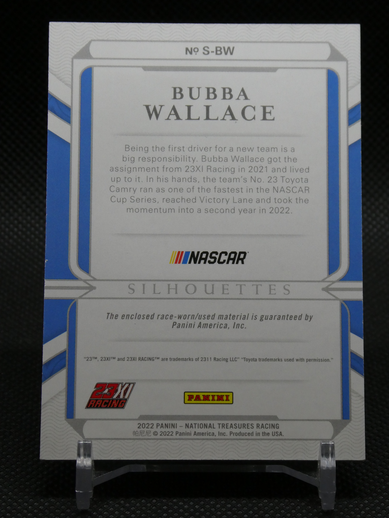 Back of a Bubba Wallace NASCAR trading card with biography text, NASCAR and Panini logos, and the word 'SILHOUETTES'