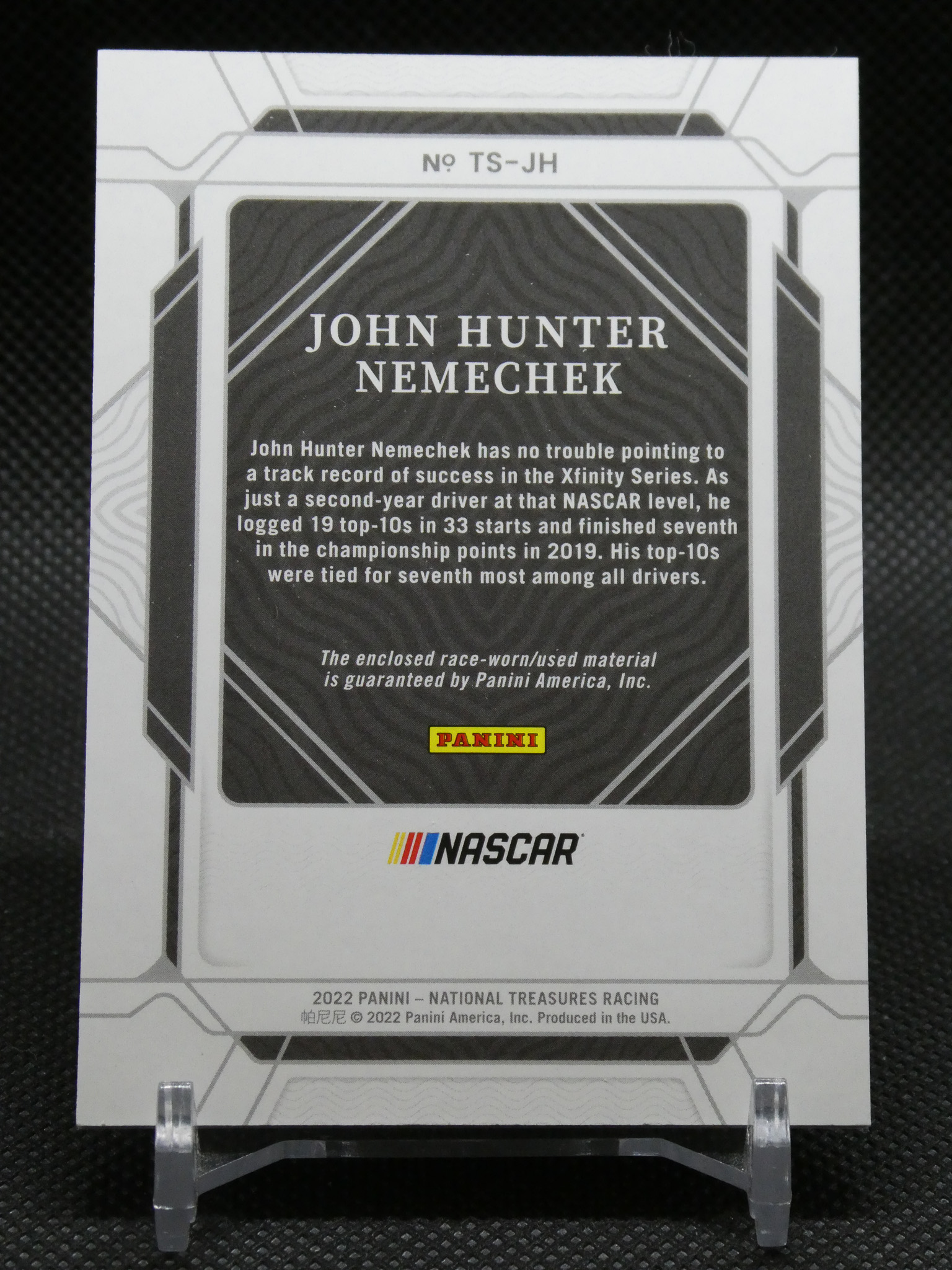 Back of a Panini NASCAR card featuring John Hunter Nemechek with a short bio and logos