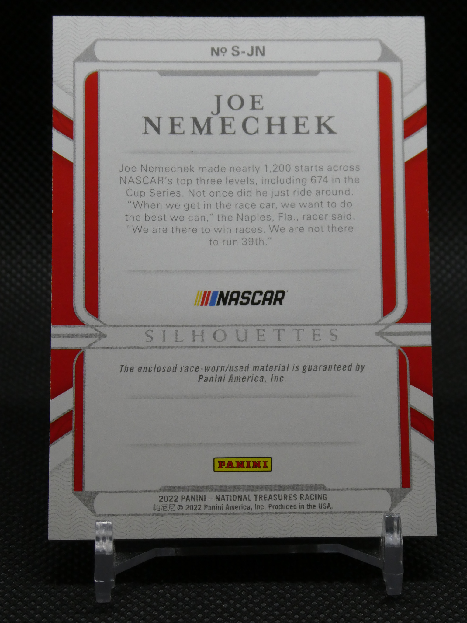 Back of a Panini NASCAR card showing 'JOE NEMECHEK' with a grey paragraph of text, NASCAR logo, and Panini branding at the bottom.