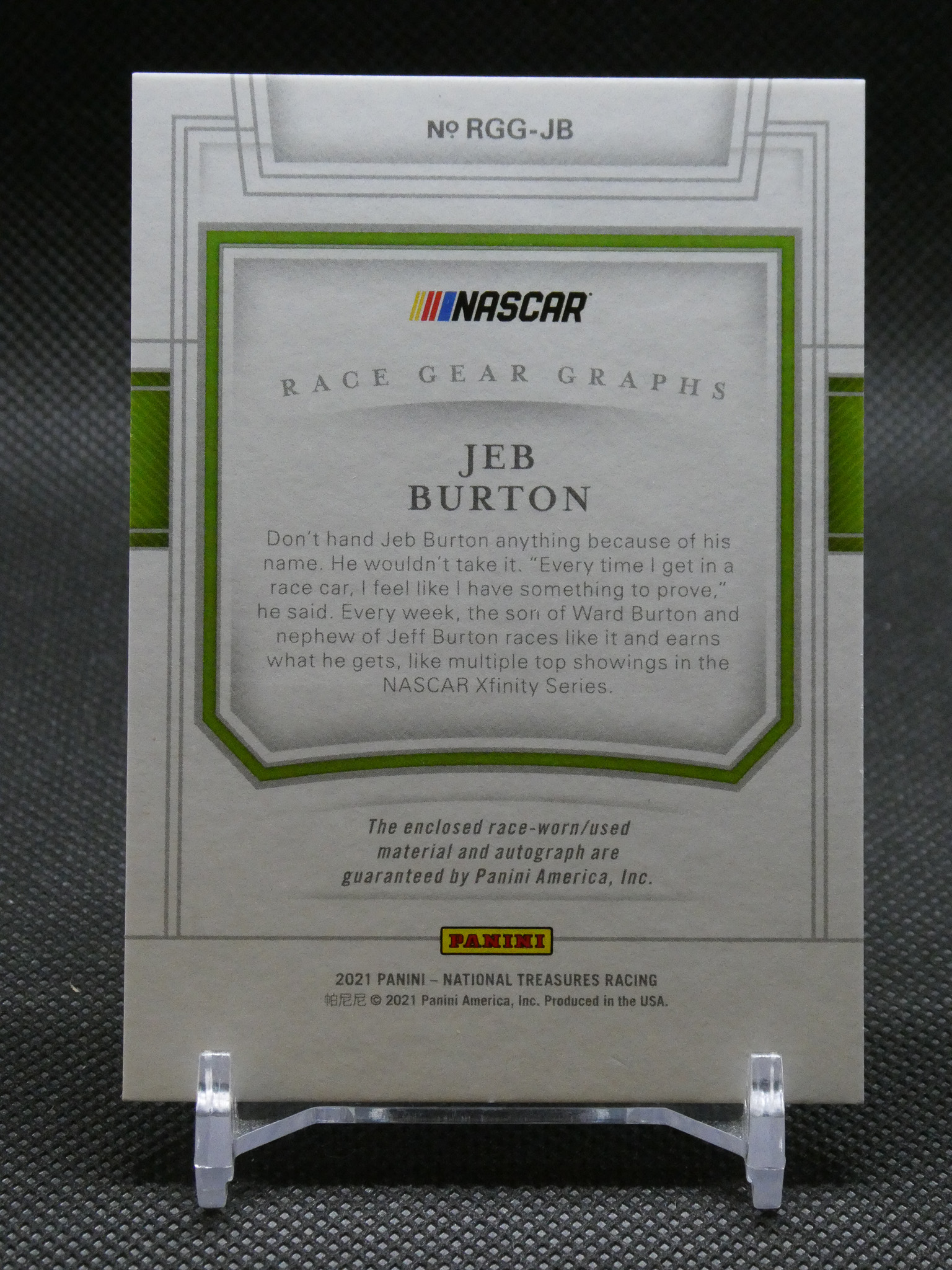 NASCAR Panini card featuring Jeb Burton with race gear graphs and descriptive paragraph, displayed in a clear plastic stand.