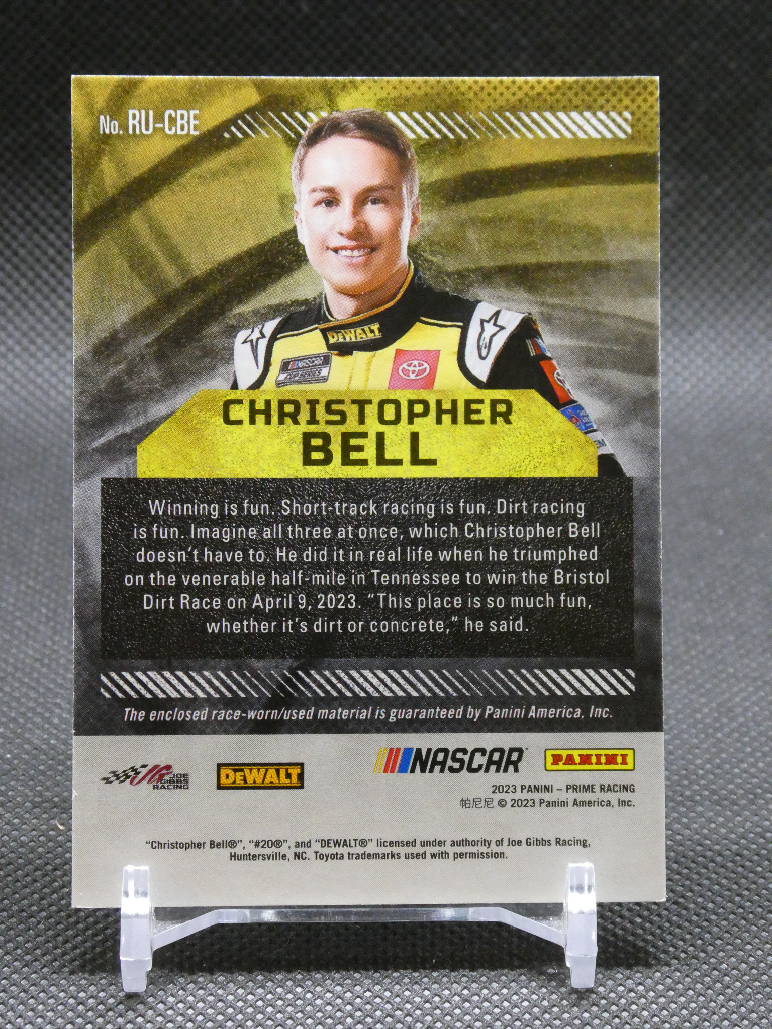 Front-facing Panini NASCAR trading card featuring driver Christopher Bell in a yellow racing suit, with 'CHRISTOPHER BELL' in bold text.