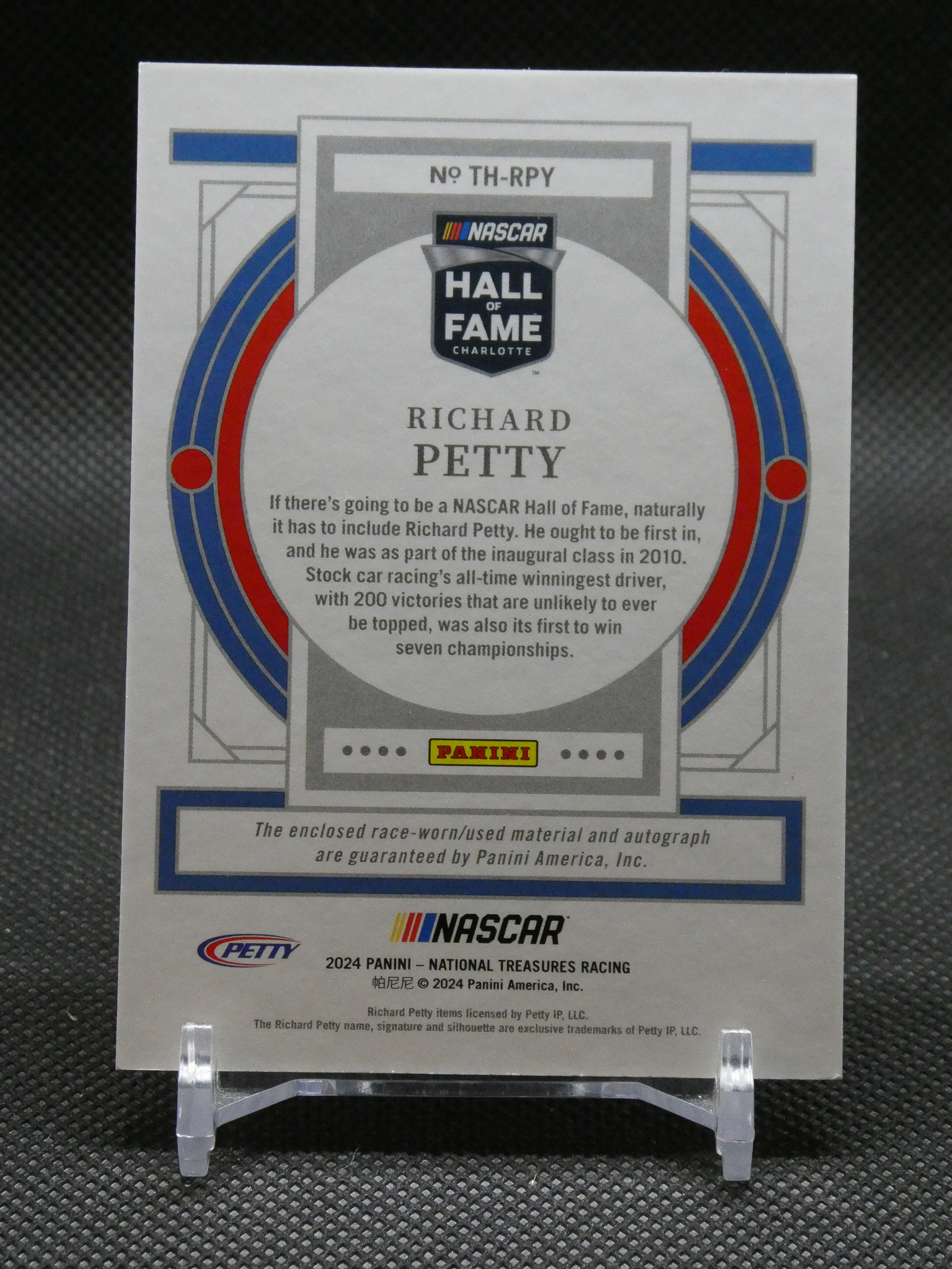 NASCAR Hall of Fame Richard Petty card with Panini logo and decorative circular frame, standing on a clear display easel