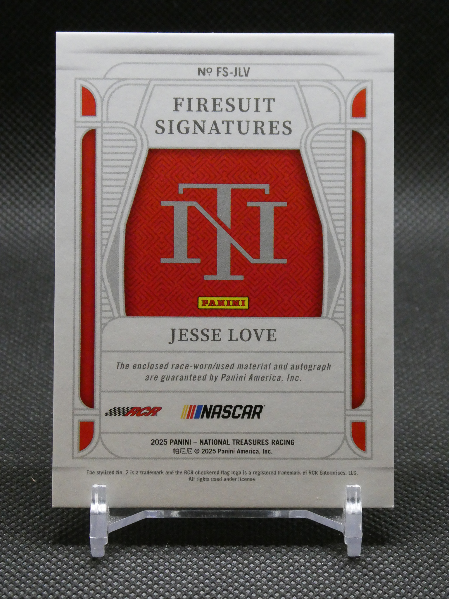 NASCAR trading card titled 'Firesuit Signatures' with a red patterned panel and a large TNT emblem, featuring Jesse Love and Panini branding.