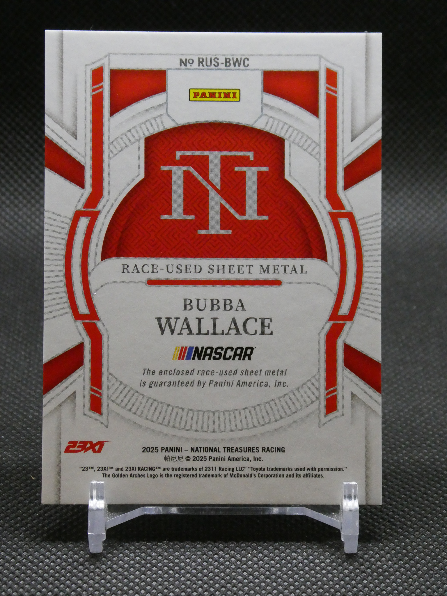 Front of a Panini NASCAR trading card with a bold red and white geometric design and the words 'Race-Used Sheet Metal.'