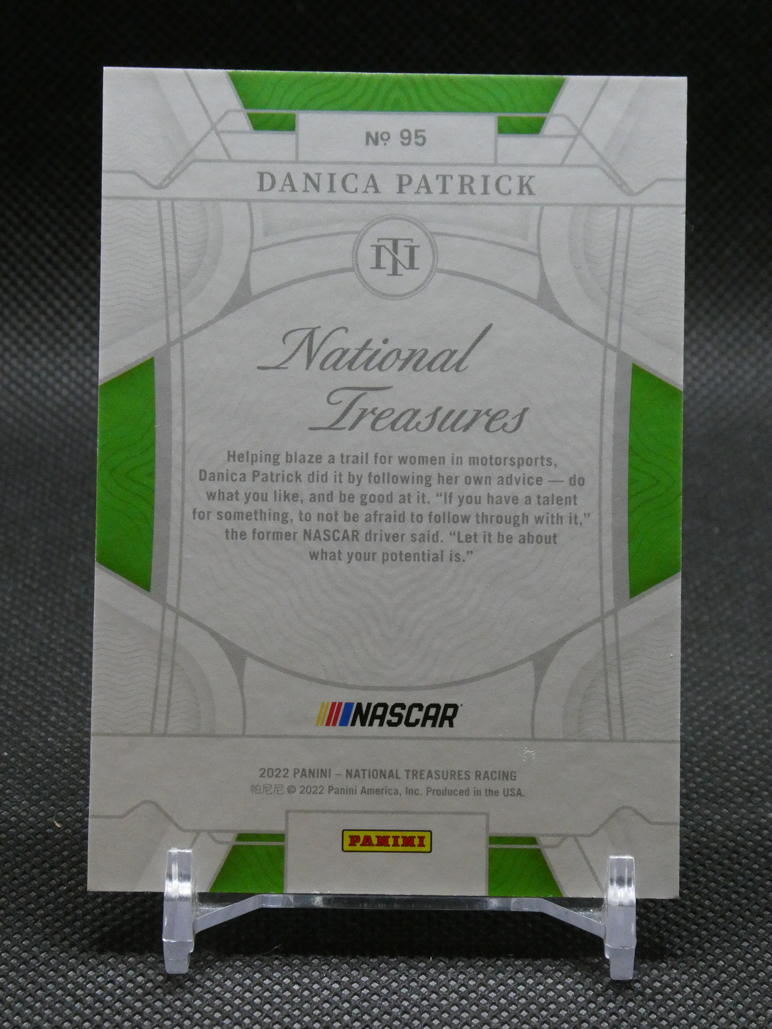 Panini National Treasures NASCAR card featuring Danica Patrick No. 95, displayed on a clear stand.