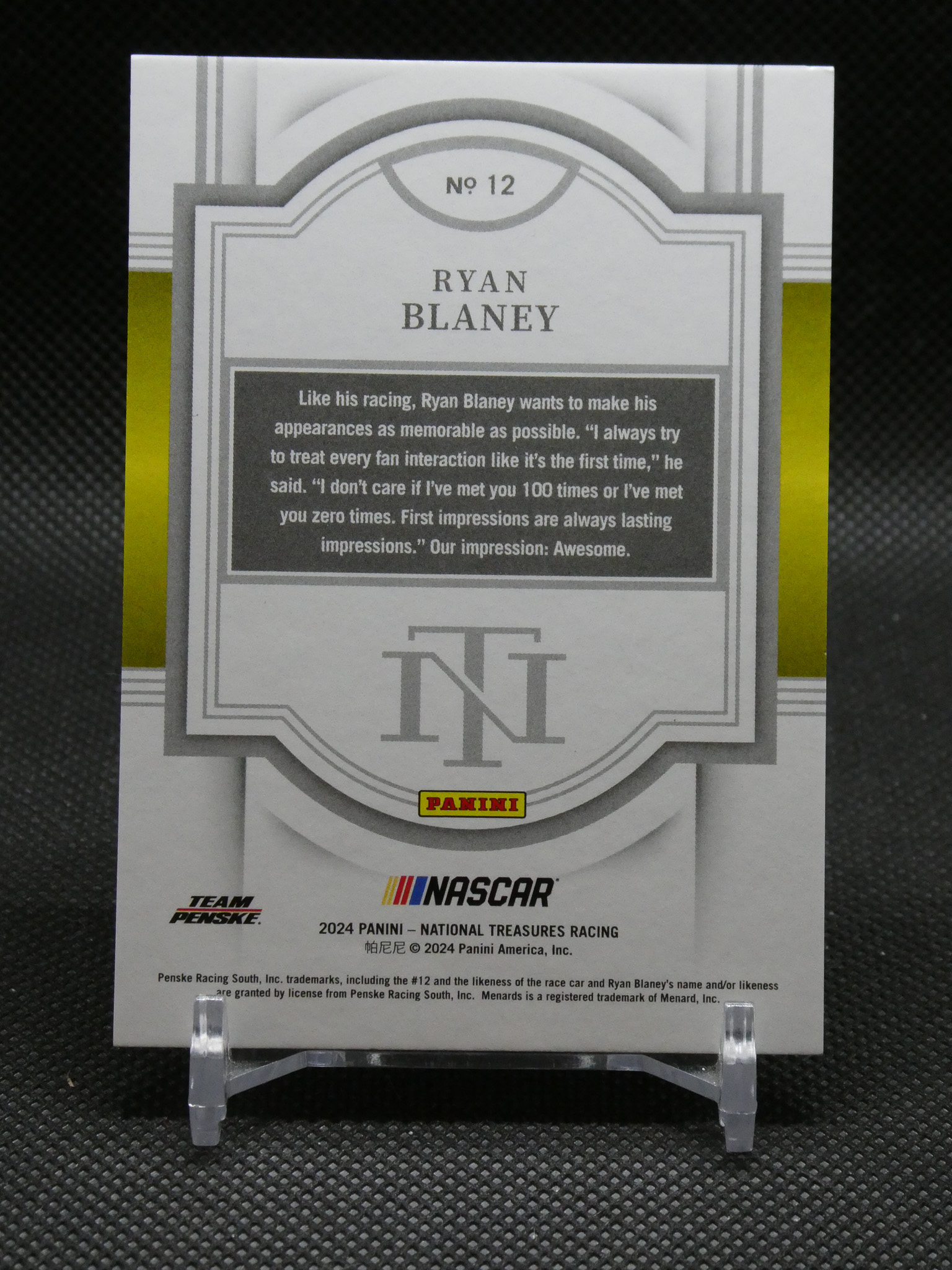 Ryan Blaney trading card No. 12 with gray decorative frame and NASCAR/NIT logos, displayed on a stand.