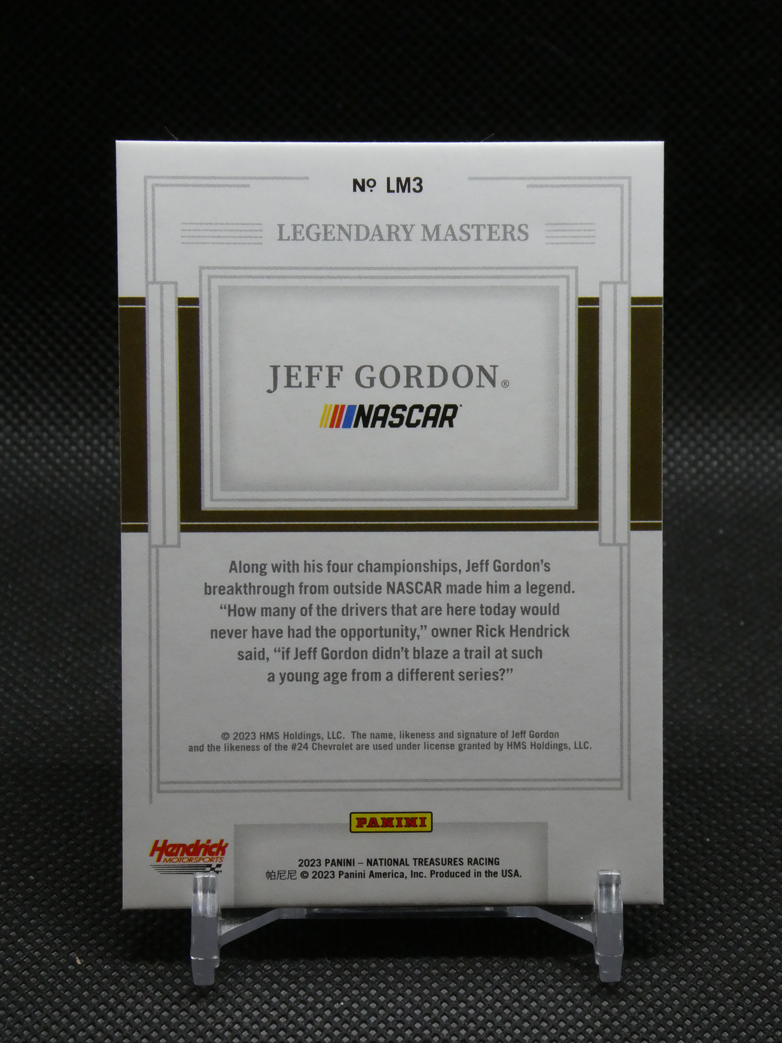 Legends Masters Jeff Gordon NASCAR card with grey decorative border on a display stand, featuring Panini and Hendrick logos.