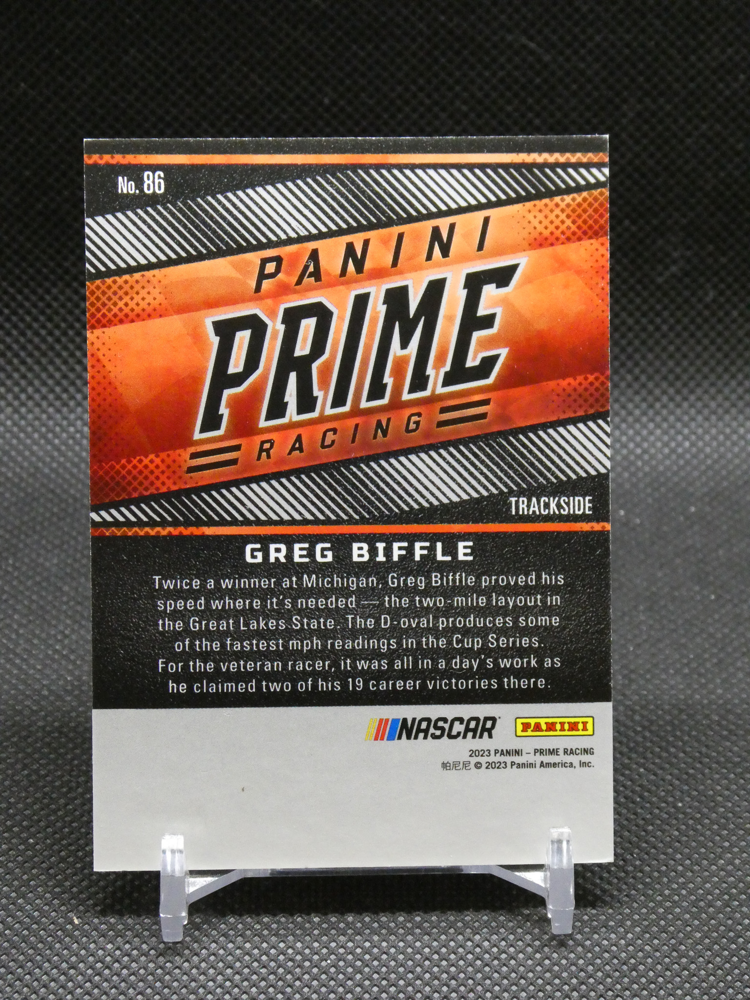 Panini Prime Racing trading card featuring Greg Biffle, with orange graphic design and racing branding.