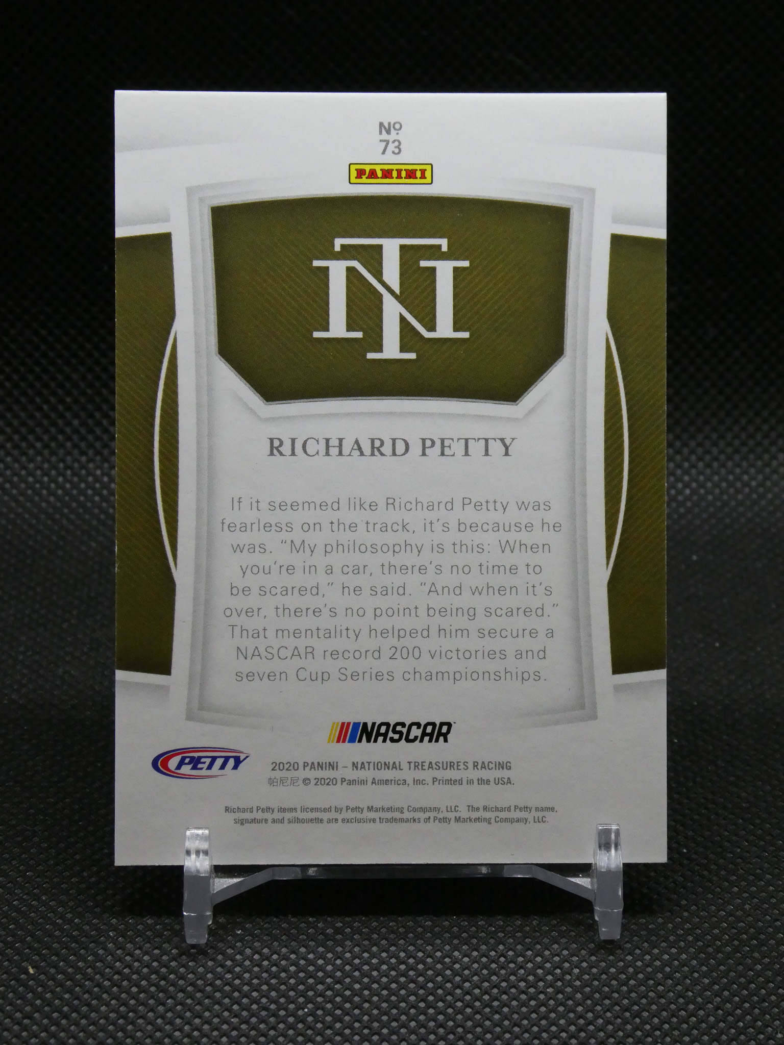 Panini trading card featuring NASCAR legend Richard Petty with a large IN logo and Nascar and Petty branding on a display stand