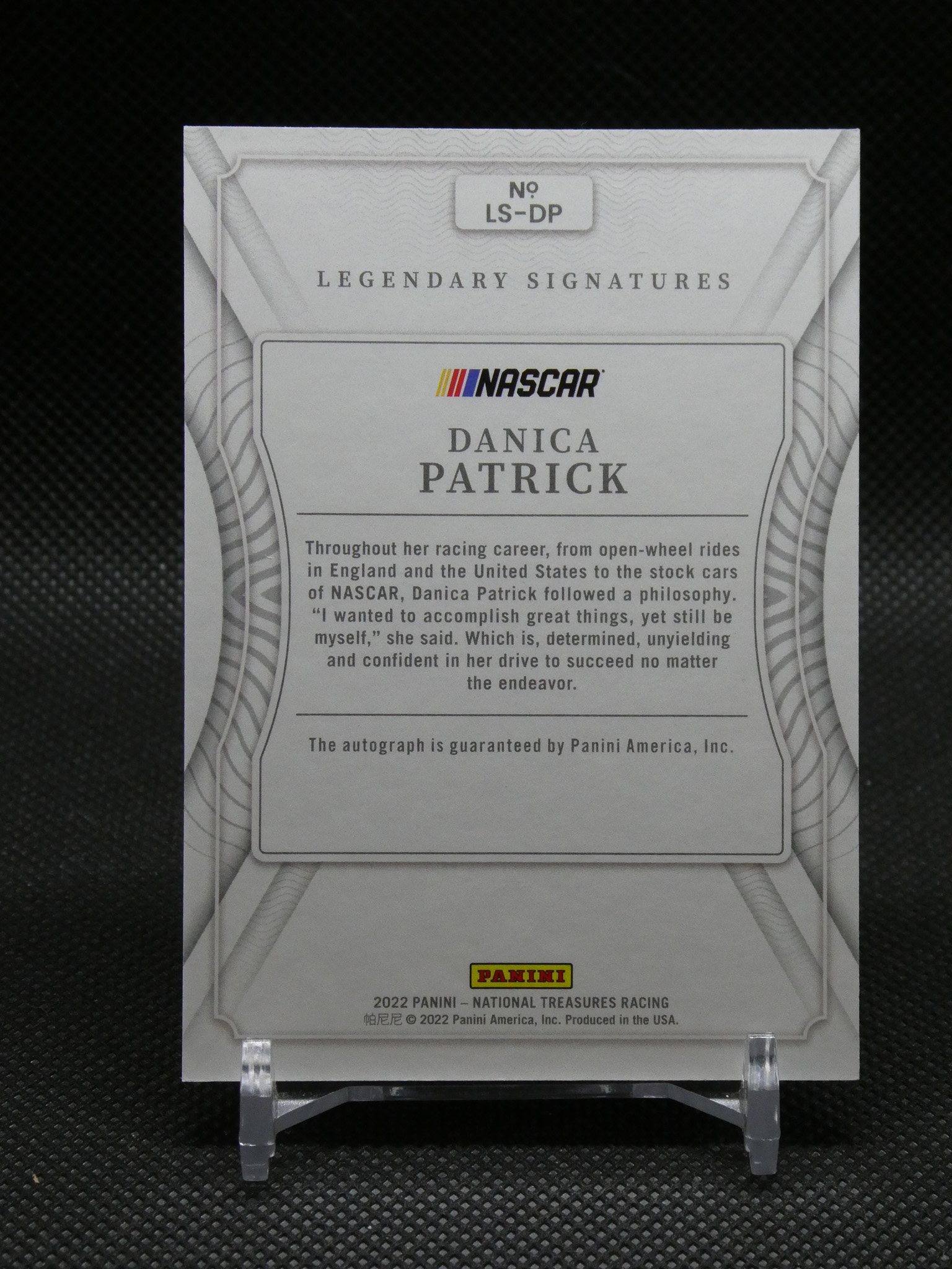 Back of a Panini NASCAR Legends Signatures card for Danica Patrick, with a bordered panel, biography text, and the Panini logo at the bottom.
