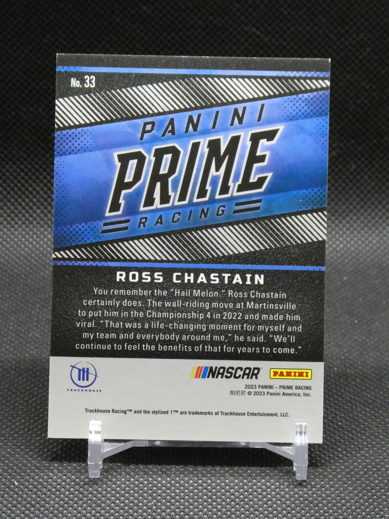 Panini Prime Racing trading card No. 33 featuring Ross Chastain on a display stand with NASCAR logos below.