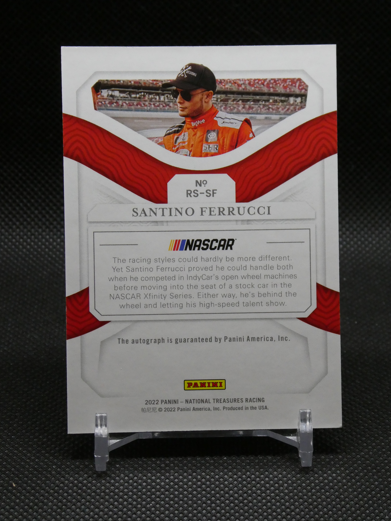 Sports trading card featuring racer Santino Ferrucci in red racing suit, with NASCAR logo and Panini branding on the backplate.
