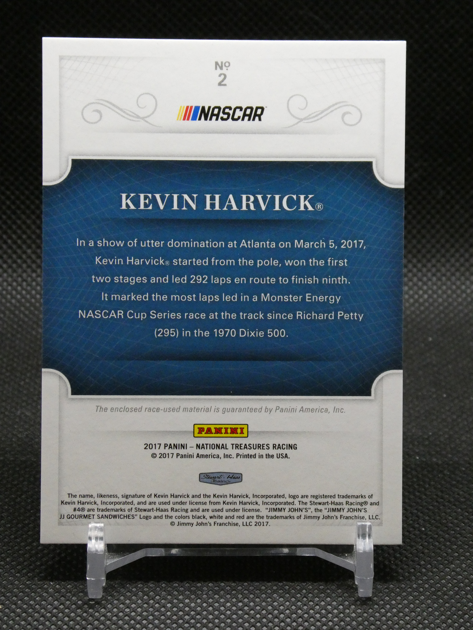 Back of a NASCAR Kevin Harvick trading card featuring a blue panel with the text KEVIN HARVICK and a paragraph about his 2017 race performance, Panini logo at bottom.