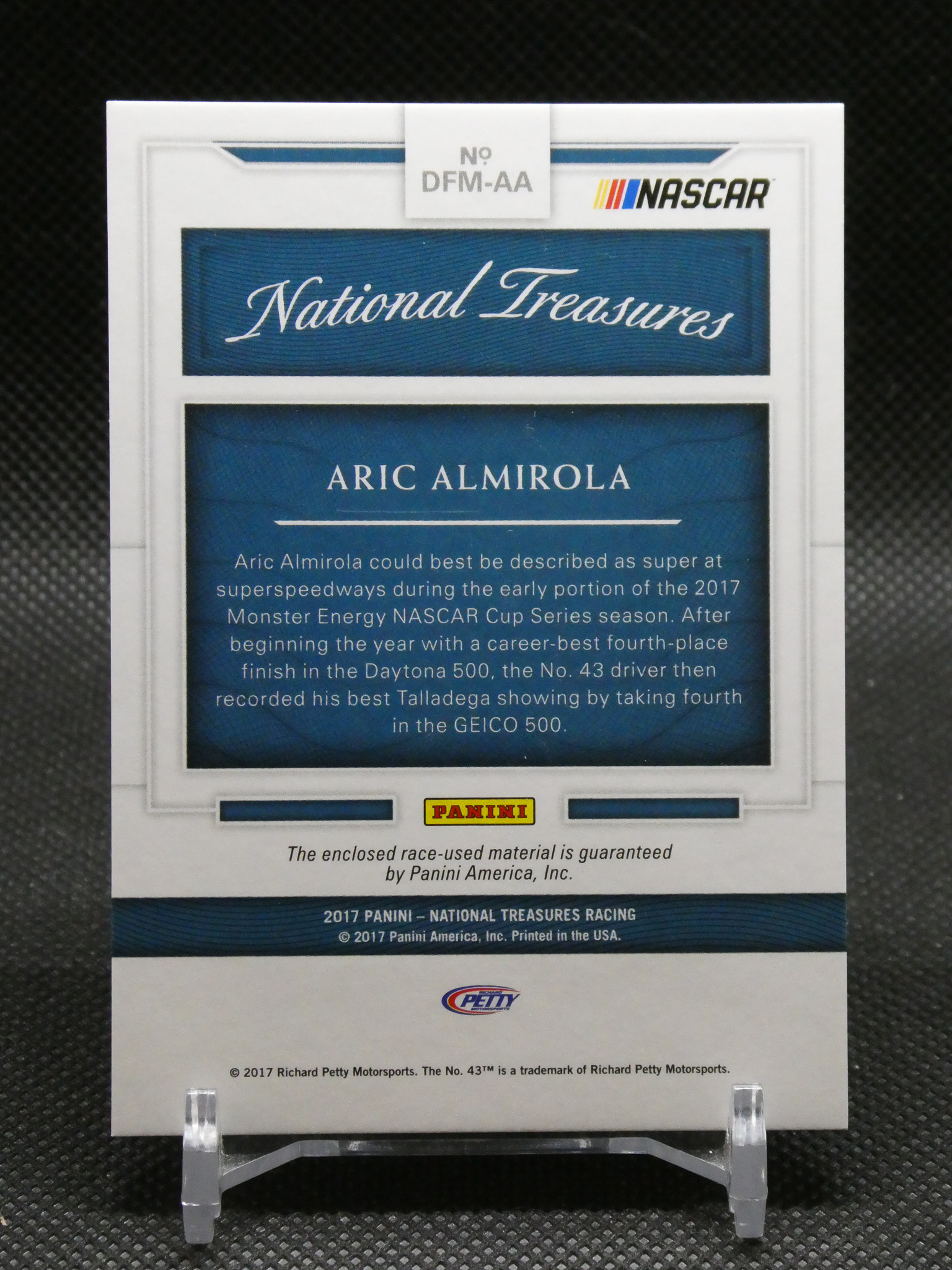 NASCAR card from Panini National Treasures featuring Aric Almirola with a blue bio panel and Panini logo above.
