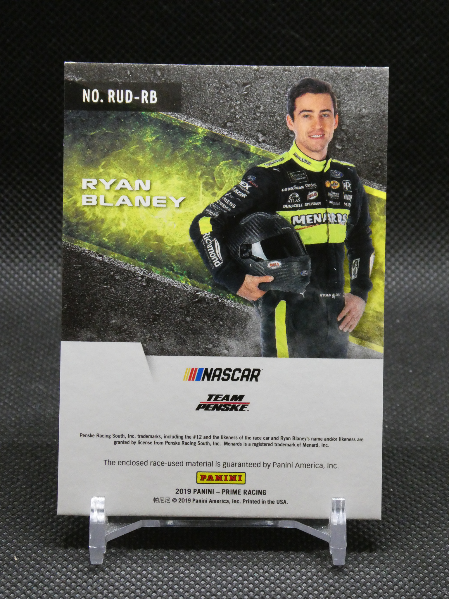 Panini NASCAR trading card of Ryan Blaney in neon-yellow and black racing suit, holding his helmet.