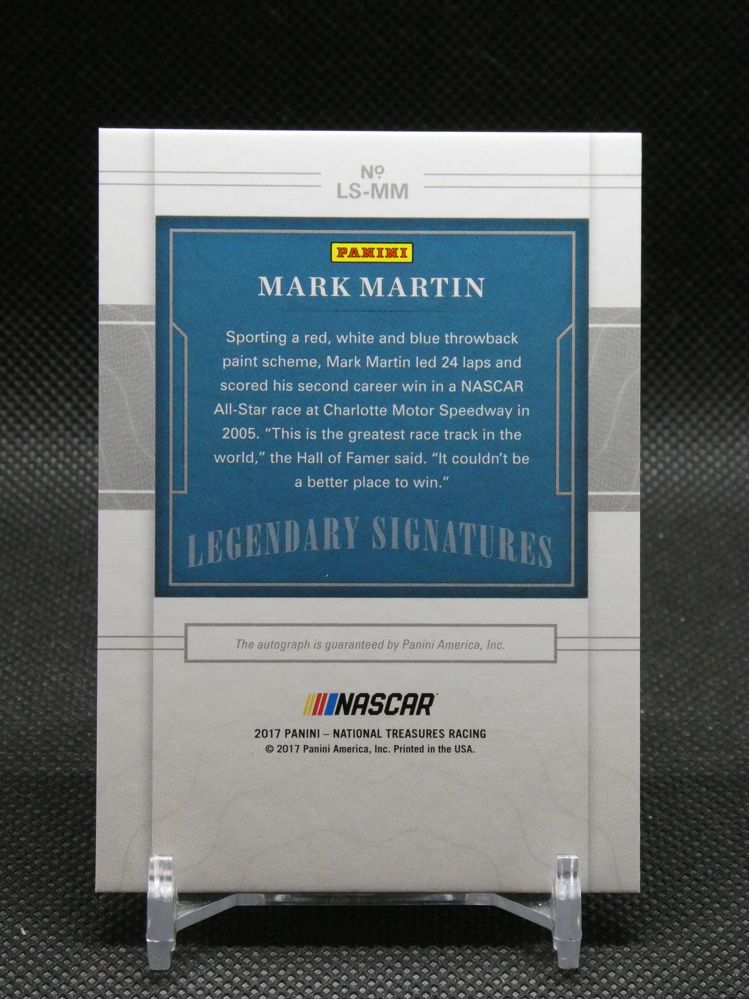 Panini Mark Martin Legendary Signatures trading card on a display stand, blue panel with text and NASCAR logo at bottom.