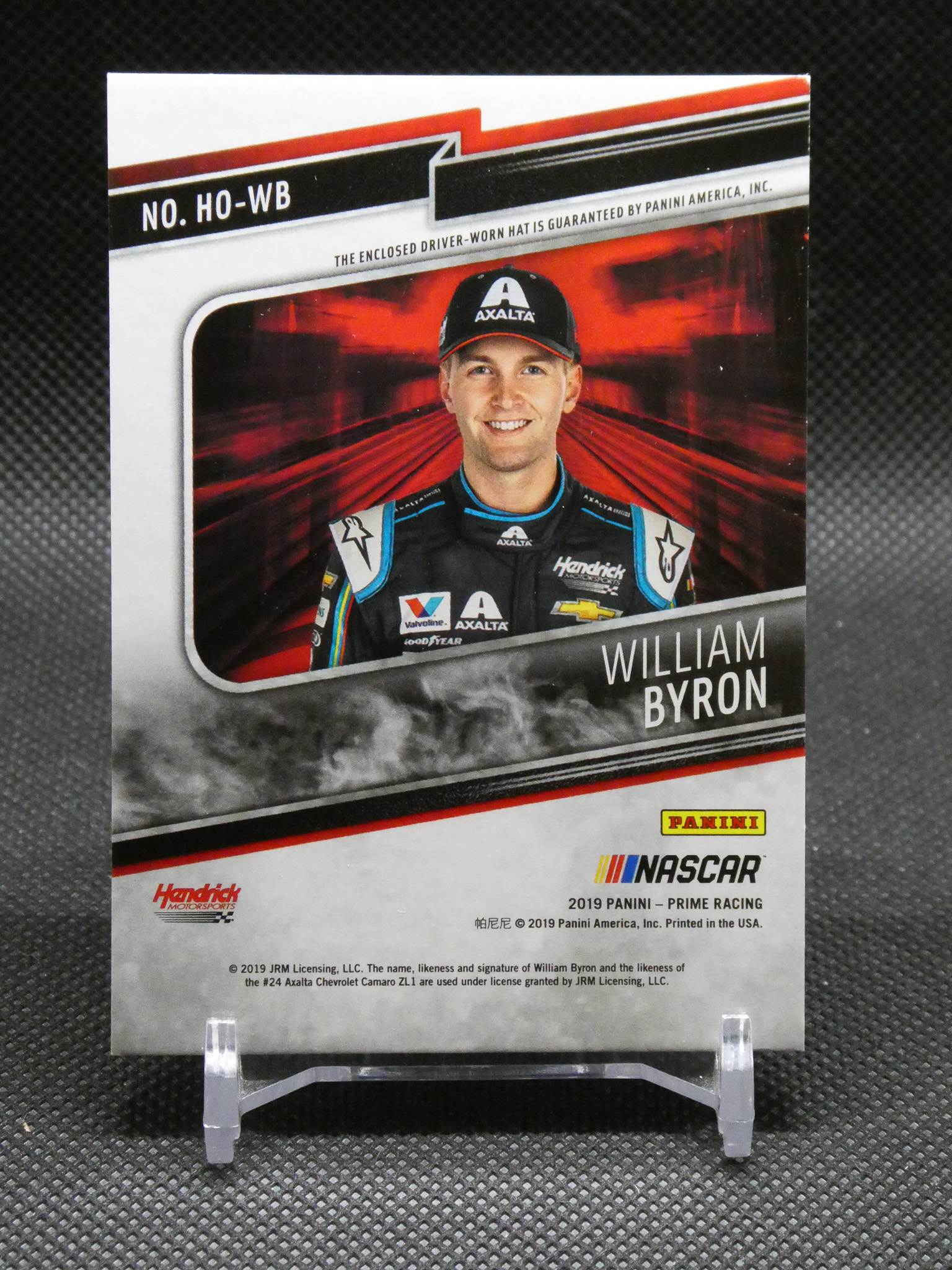 Panini NASCAR trading card featuring William Byron in a racing suit and cap, with logos and red background.
