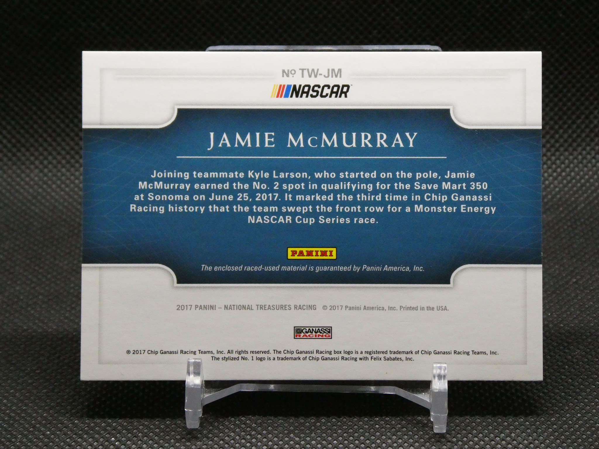 NASCAR Panini trading card back featuring Jamie McMurray in a blue panel with descriptive text about his race history and Panini logo at bottom center.