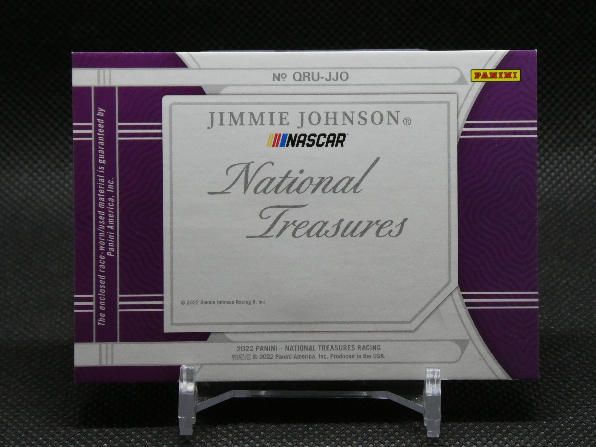 Purple and silver Panini NASCAR National Treasures box with Jimmie Johnson branding on a display stand, front-facing promotional packaging.