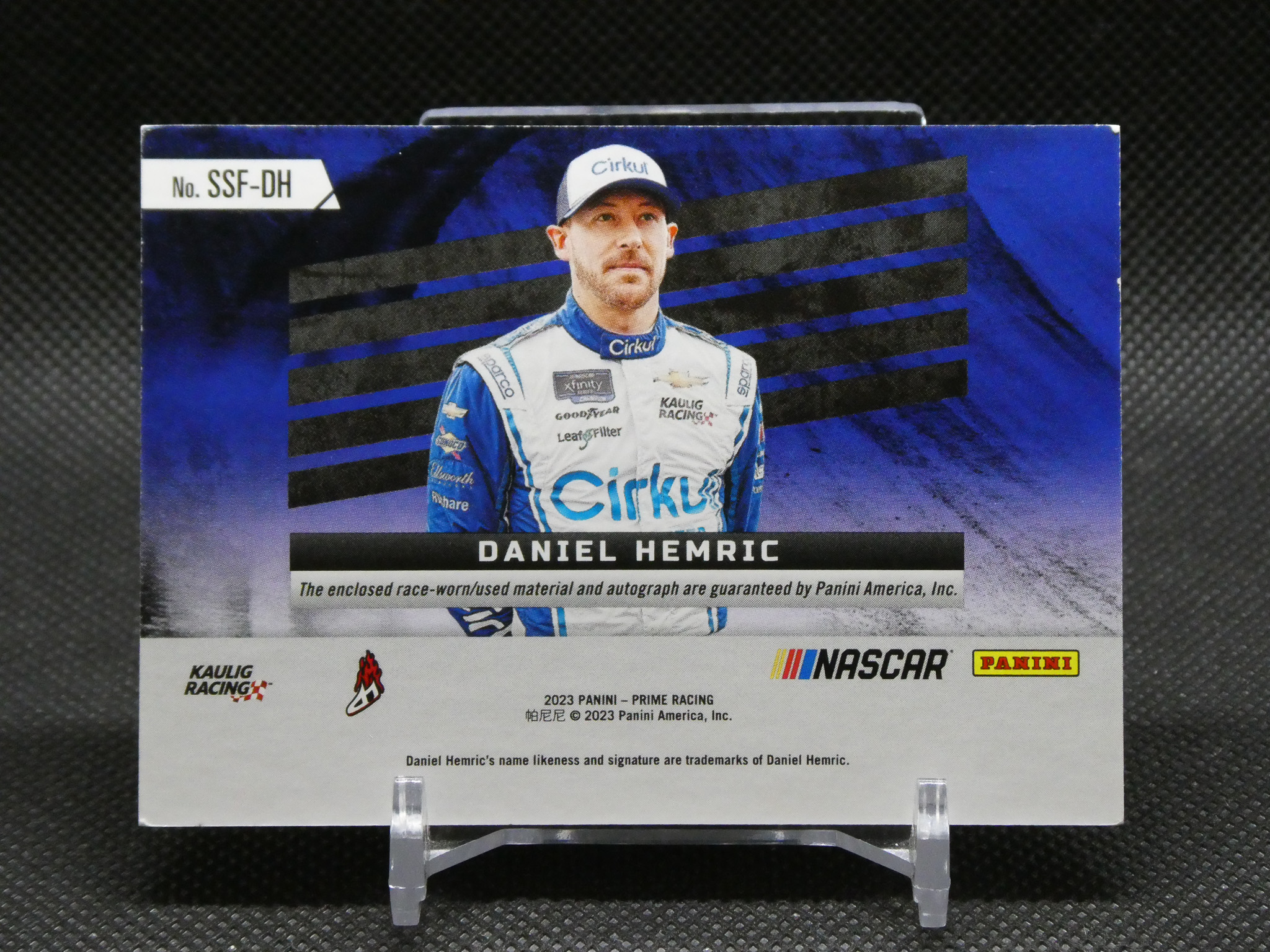 Trading card featuring NASCAR driver Daniel Hemric in a blue racing suit with sponsor logos.