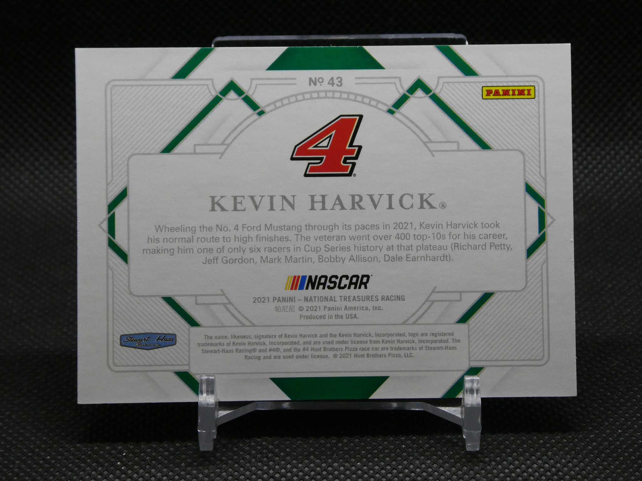 Kevin Harvick 4 NASCAR card back with Panini logo and green decorative borders, displayed on a stand.