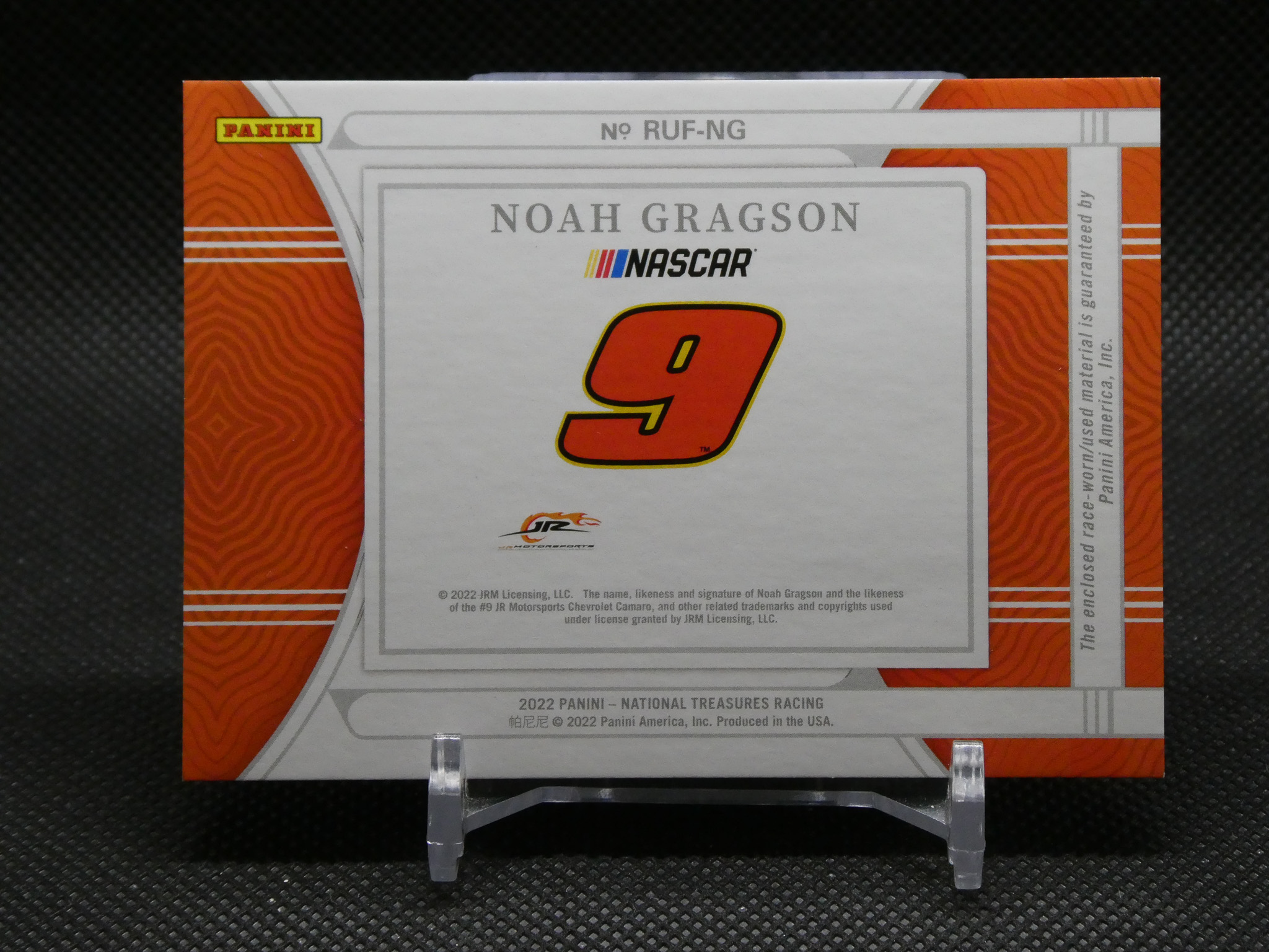 Front of a Panini NASCAR trading card box featuring Noah Gragson, large orange number 9, white central panel, orange patterned sides.