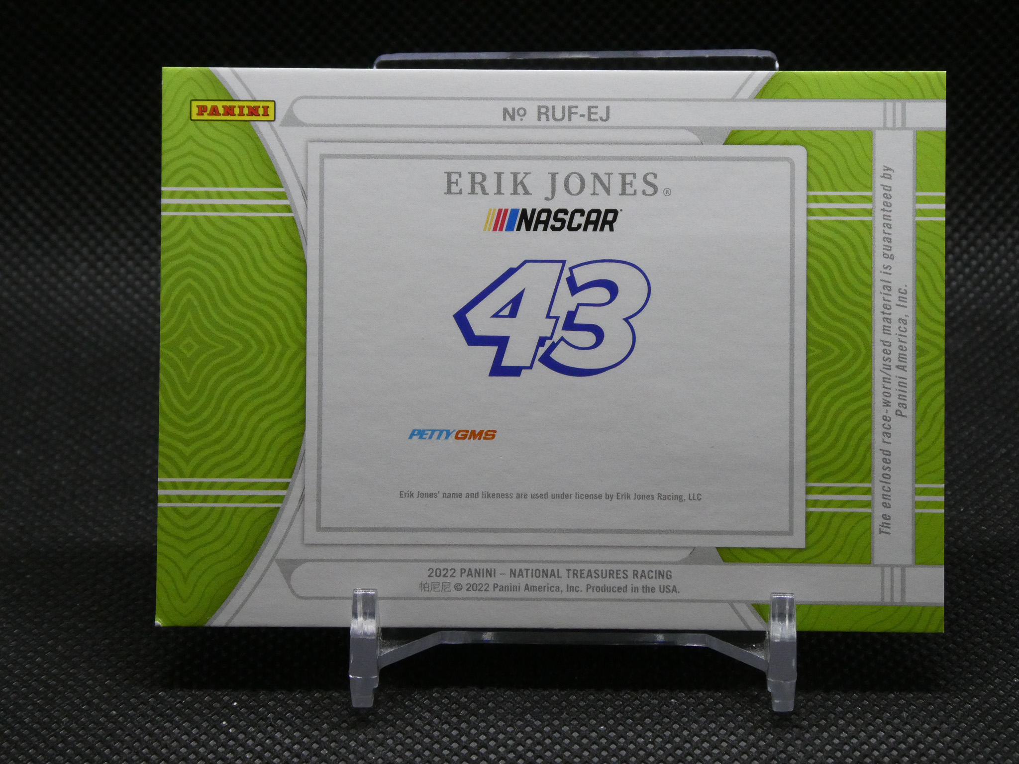 Panini Erik Jones NASCAR card box featuring number 43 on a lime-green patterned box displayed on a stand.
