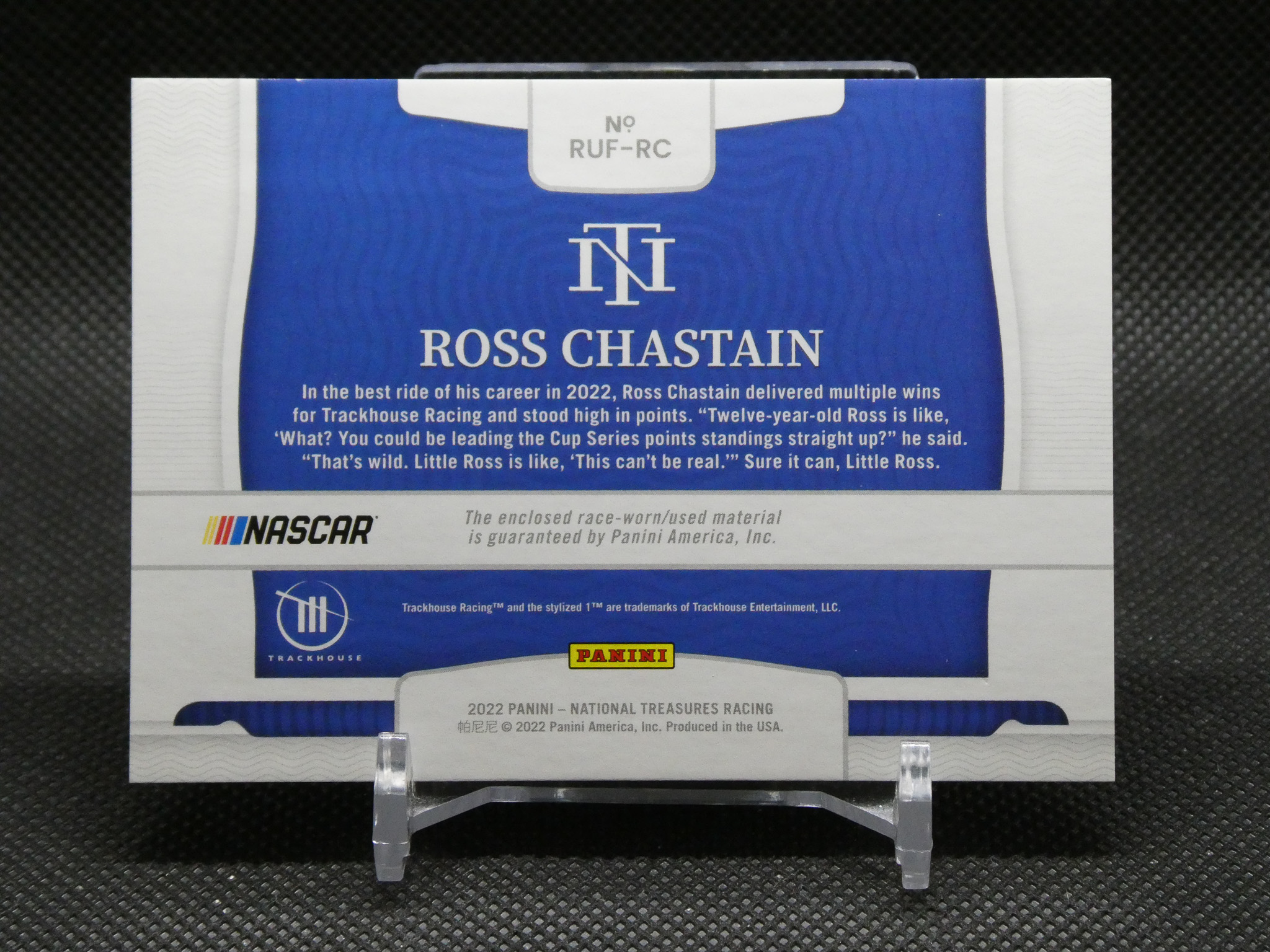 Panini NASCAR trading card box featuring Ross Chastain with a blue panel and NASCAR branding on a display stand.