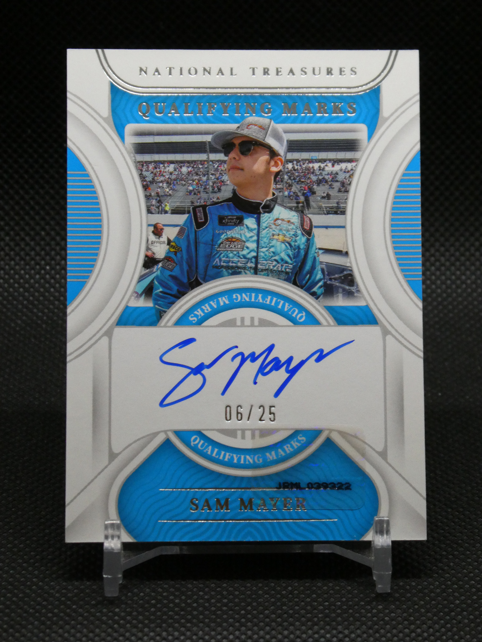 Signed Sam Mayer racing card featuring the driver in a blue suit and cap, autograph visible with a track crowd in the background.