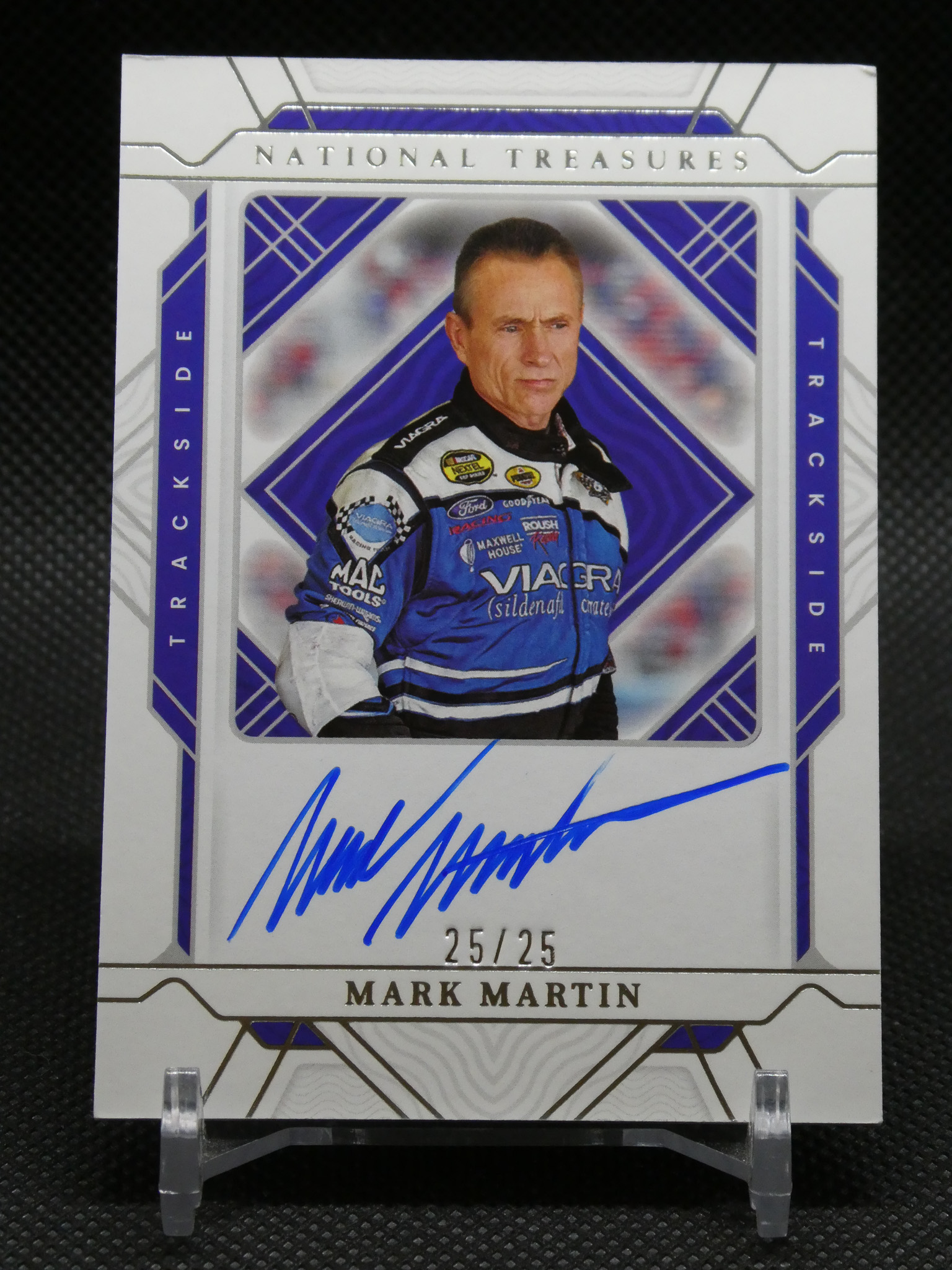 Limited edition autographed racing card of Mark Martin from National Treasures, displaying a blue-suited driver with a blue signature and 25/25 serial number.
