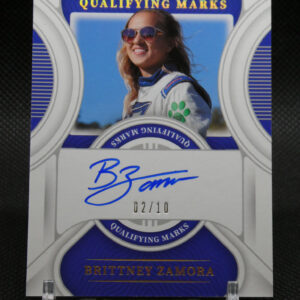 Autographed trading card of Britney Zamora in a white racing suit with sunglasses, blue background, serial 02/10, saying 'Qualifying Marks' and 'National Treasures'.