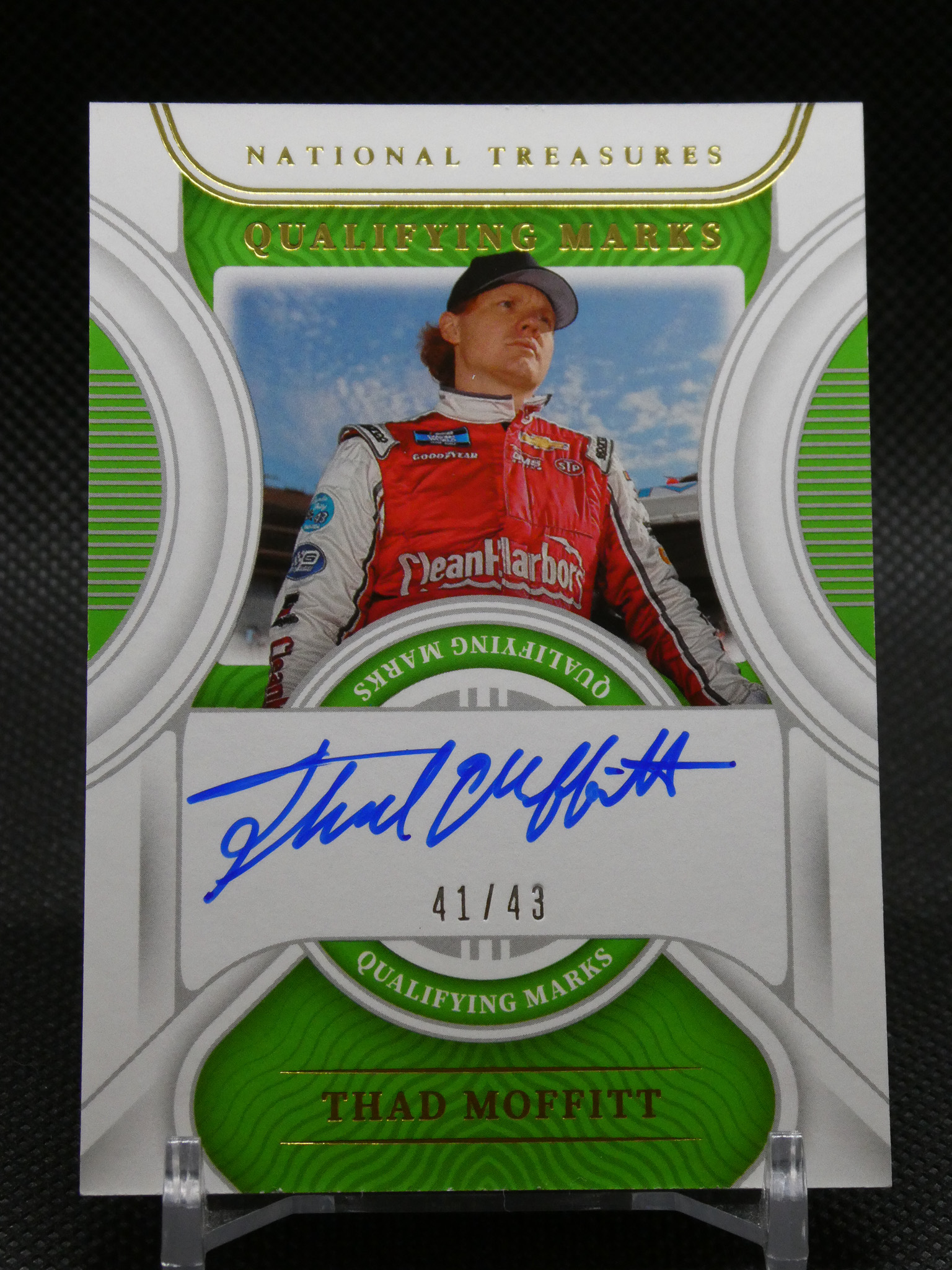 Autographed trading card of racecar driver Thad Moffitt, edition 41 of 43, in a red racing suit.