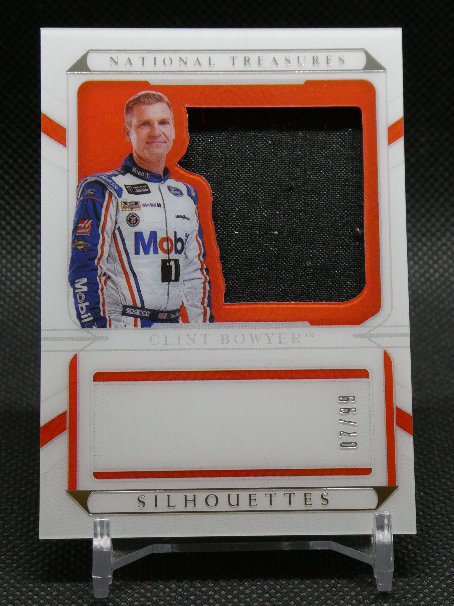 Carded display featuring a life-size cutout of NASCAR driver Clint Bowyer in his white-blue racing suit within an orange-framed National Treasures Silhouettes package.