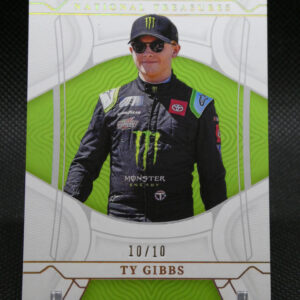National Treasures trading card of Ty Gibbs, driver in a black Monster Energy suit with green decorative background and sunglasses.