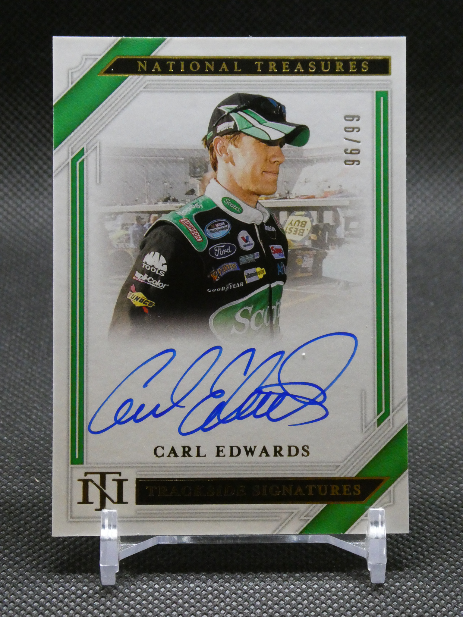 Trading card featuring NASCAR driver Carl Edwards with his autograph in blue ink on a white background with green accents.