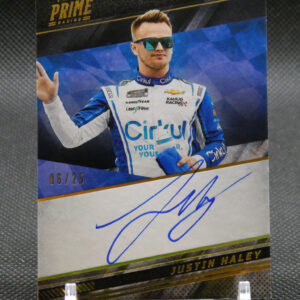 Autographed Panini Prime Racing card showing a driver in blue-and-white suit with sunglasses; signature across bottom edge.