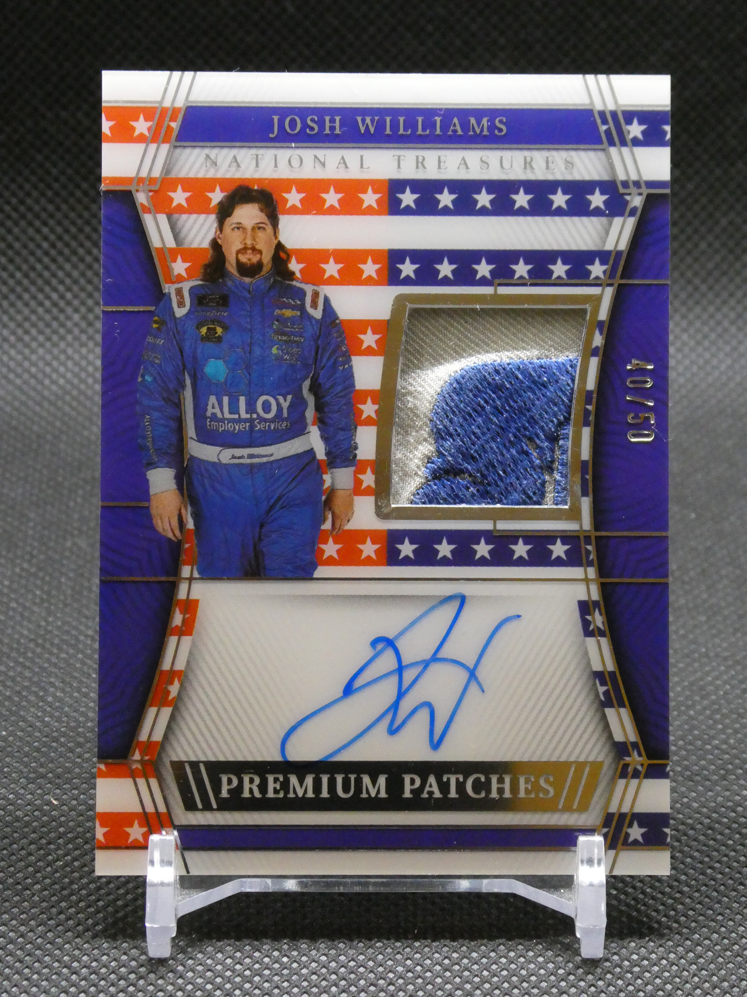 Trading card featuring Josh Williams in a blue racing suit, with a blue fabric patch and autograph streak across the bottom.