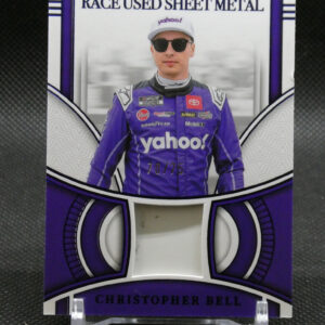 Widely spaced image of a NASCAR collector card featuring Christopher Bell in a purple racing suit with 'yahoo' on the cap and sunglasses, captioned 'RACE USED SHEET METAL' and 'CHRISTOPHER BELL' at the bottom.