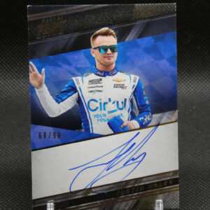 Portrait of a race car driver in a blue-and-white suit with mirrored sunglasses, waving from a signed poster on display.
