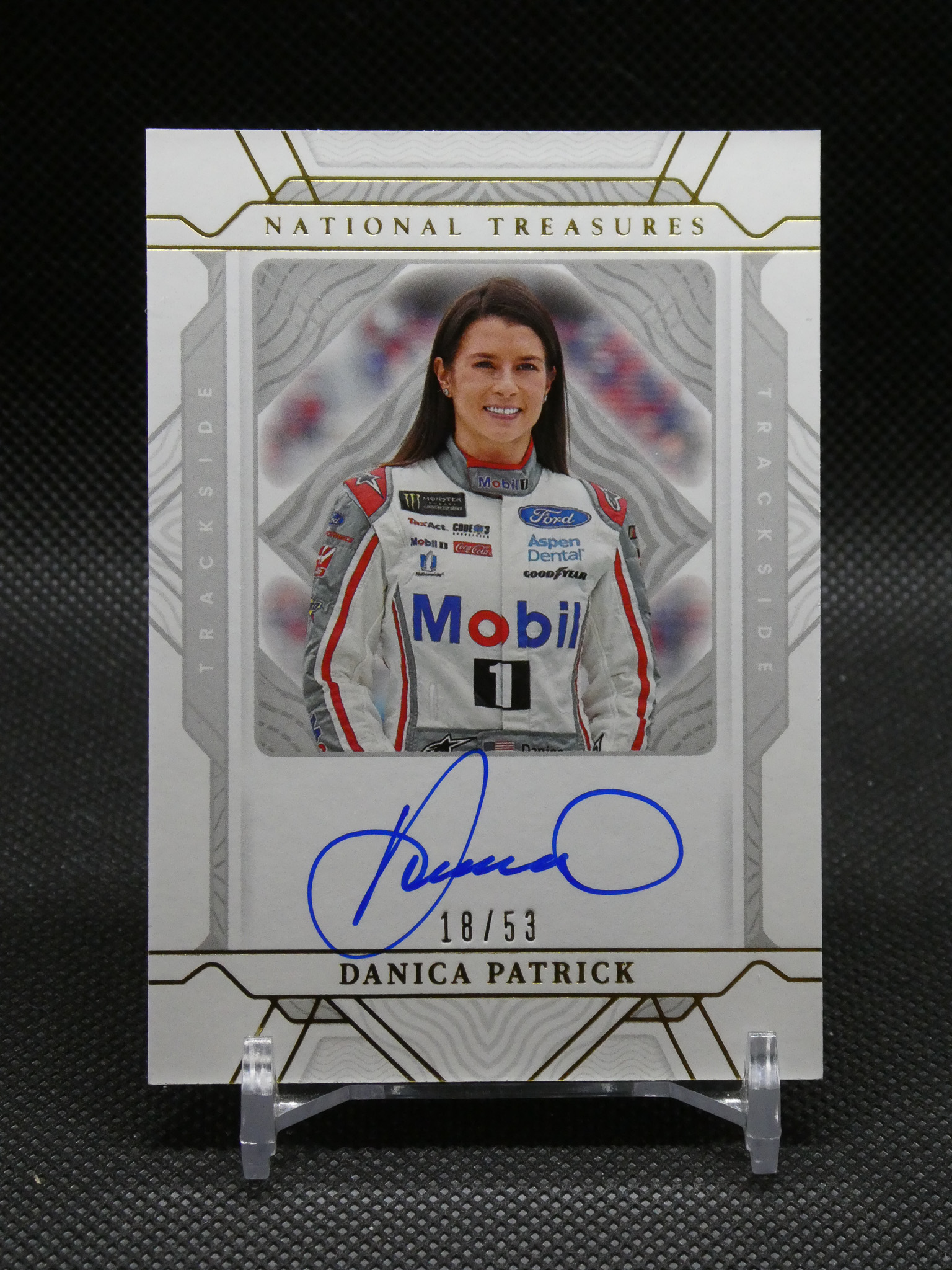 Signed Danica Patrick trading card from National Treasures, showing her in a racing suit with autograph and 18/53 edition stamp.