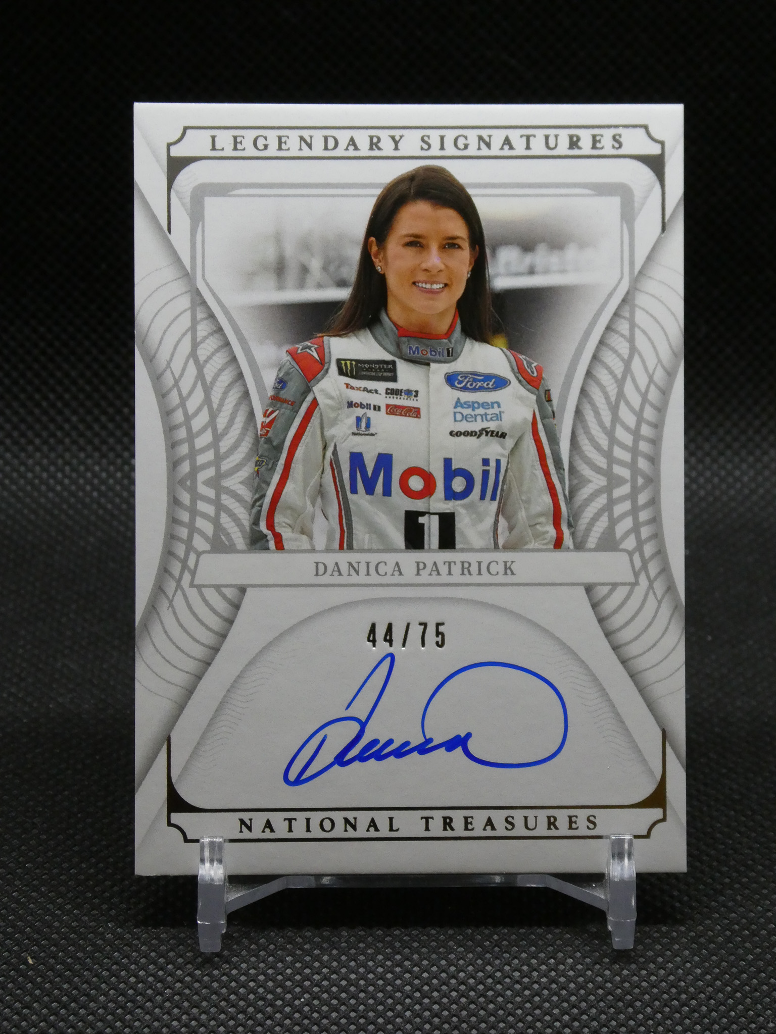 Autographed Danica Patrick racing card from National Treasures, edition 44/75, featuring her photo in racing suit and signature.