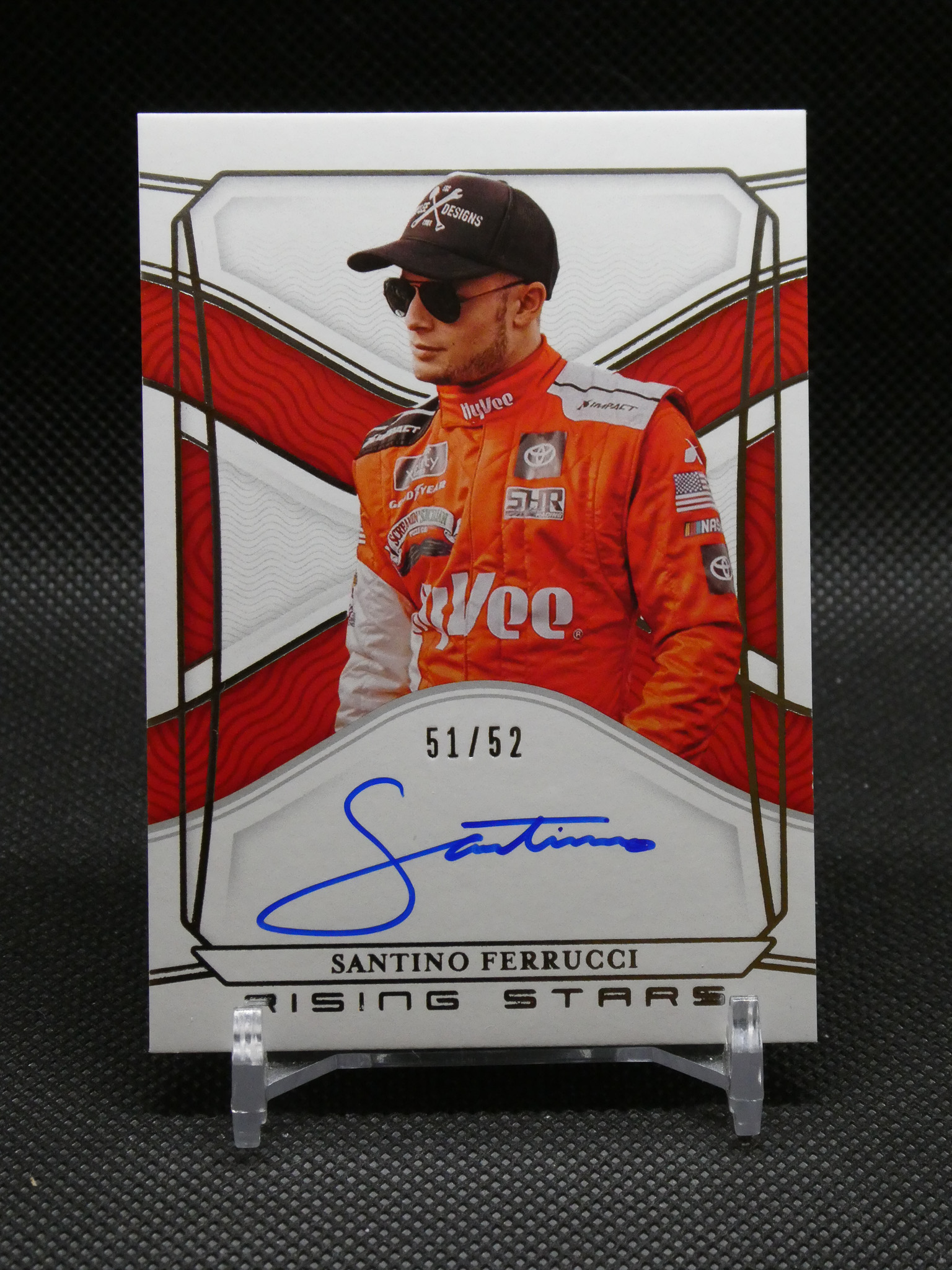 Autographed racing trading card featuring driver Santino Ferrucci in an orange suit, wearing sunglasses and a cap, numbered 51/52.