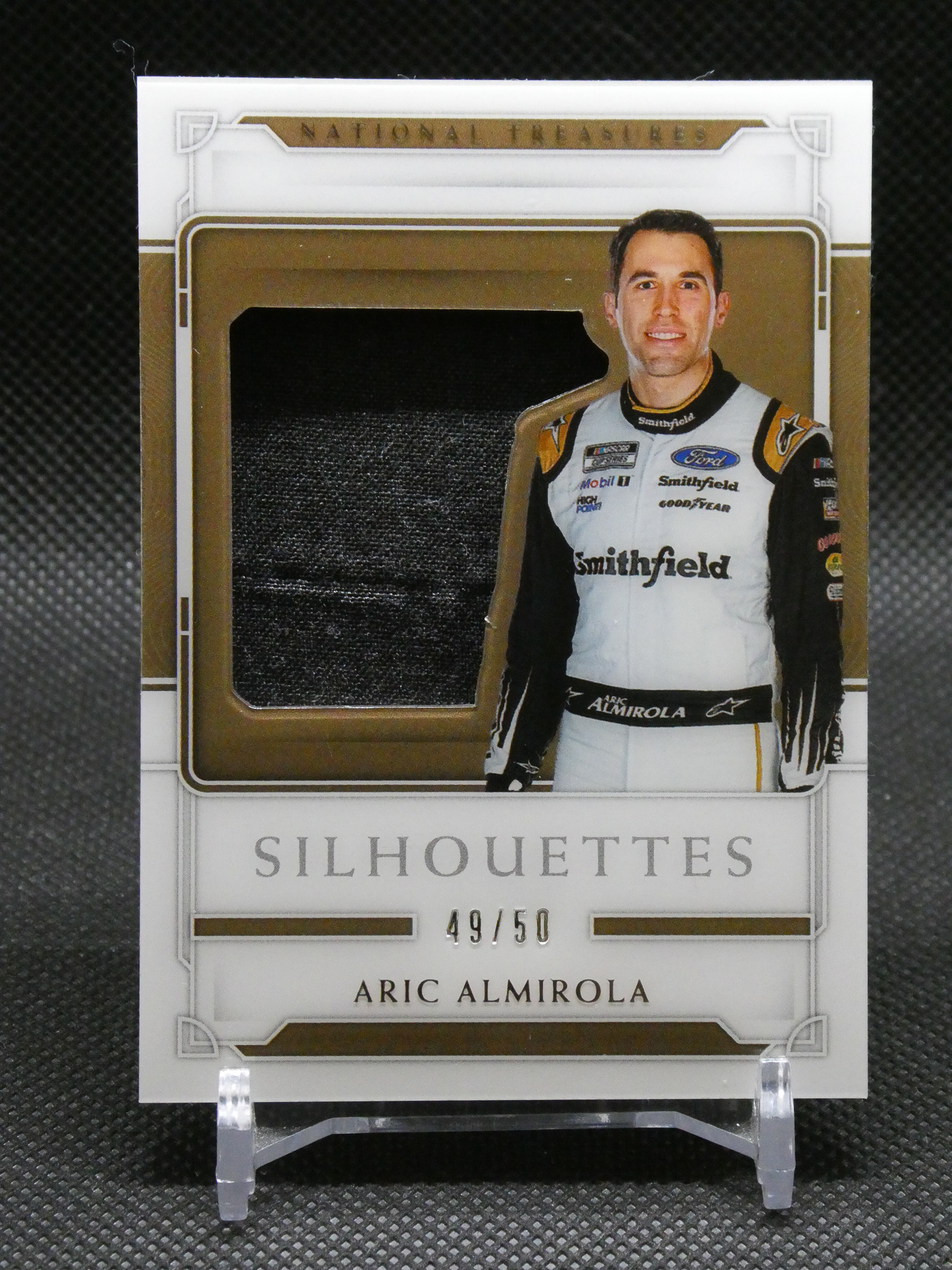 Limited edition Silhouettes trading card of NASCAR driver Aric Almirola, 49 of 50, with sponsor logos on his racing suit.