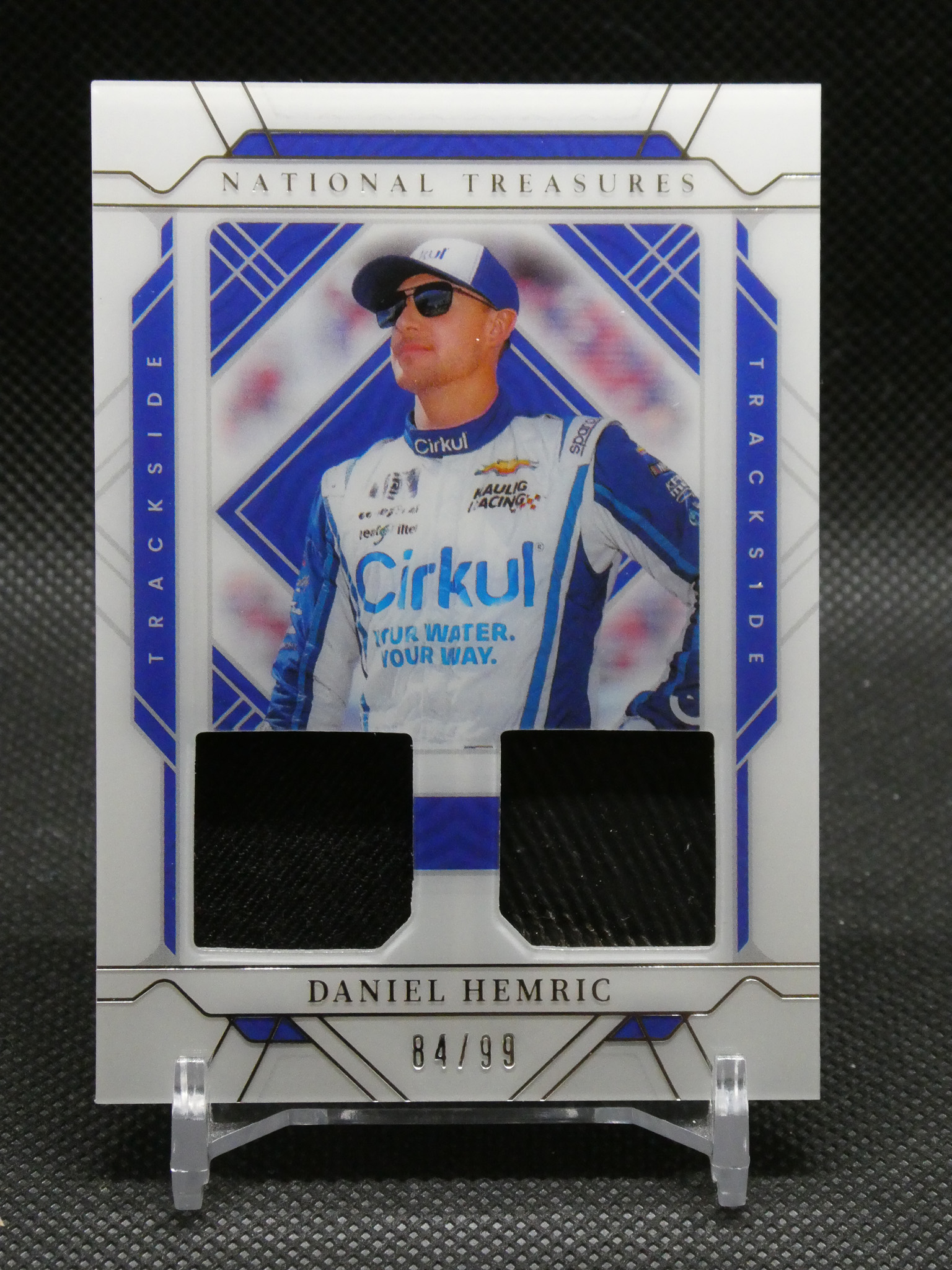 Trading card portrait of NASCAR driver Daniel Hemric in a white-blue frame reading 84/99 at the bottom.