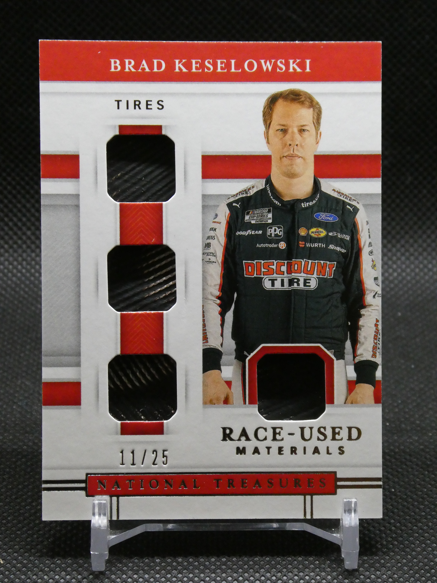 Poster featuring NASCAR driver Brad Keselowski in racing suit beside a tire display, titled 'Brad Keselowski' with 'TIRES' branding and sponsor logos