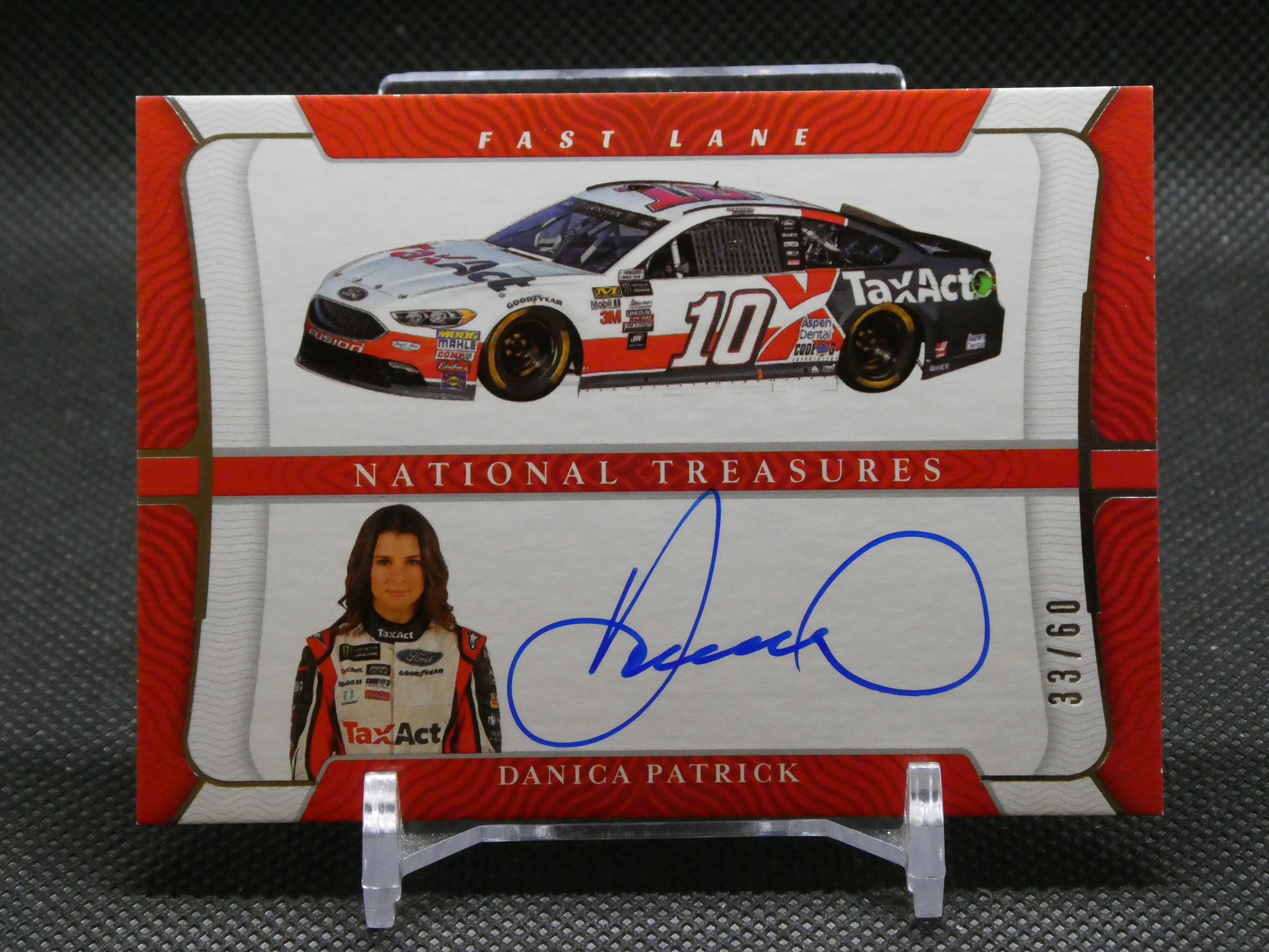 Autographed Danica Patrick trading card display with a signed photo and a race car image above it.