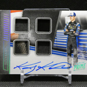 Autographed racing card showing a driver in a blue-and-black suit beside a garage backdrop, blue signature across the bottom